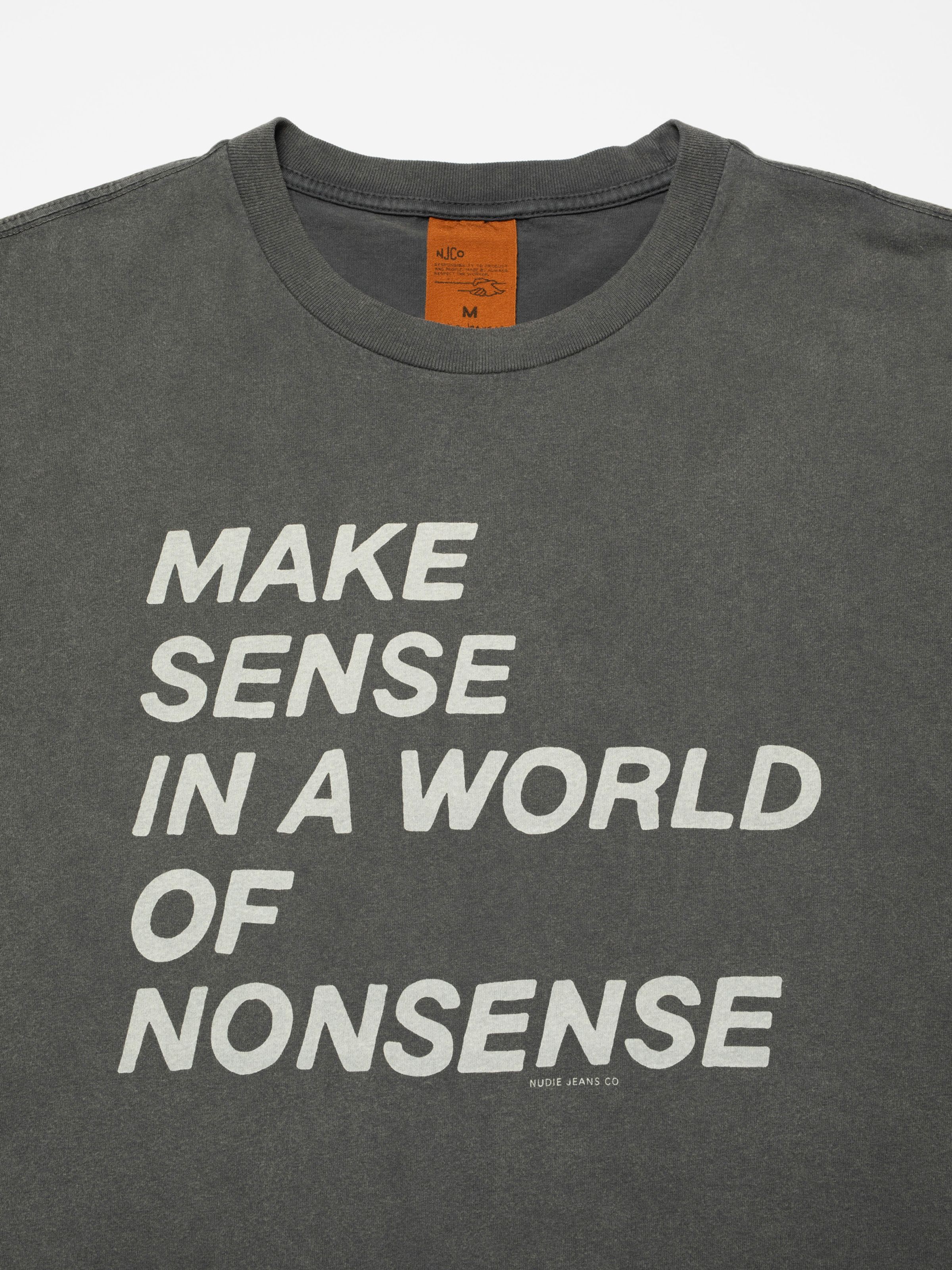 Nudie Jeans Roy T-Shirt Make Sense in Antracite, close-up of the 'MAKE SENSE IN A WORLD OF NONSENSE' chest print.
