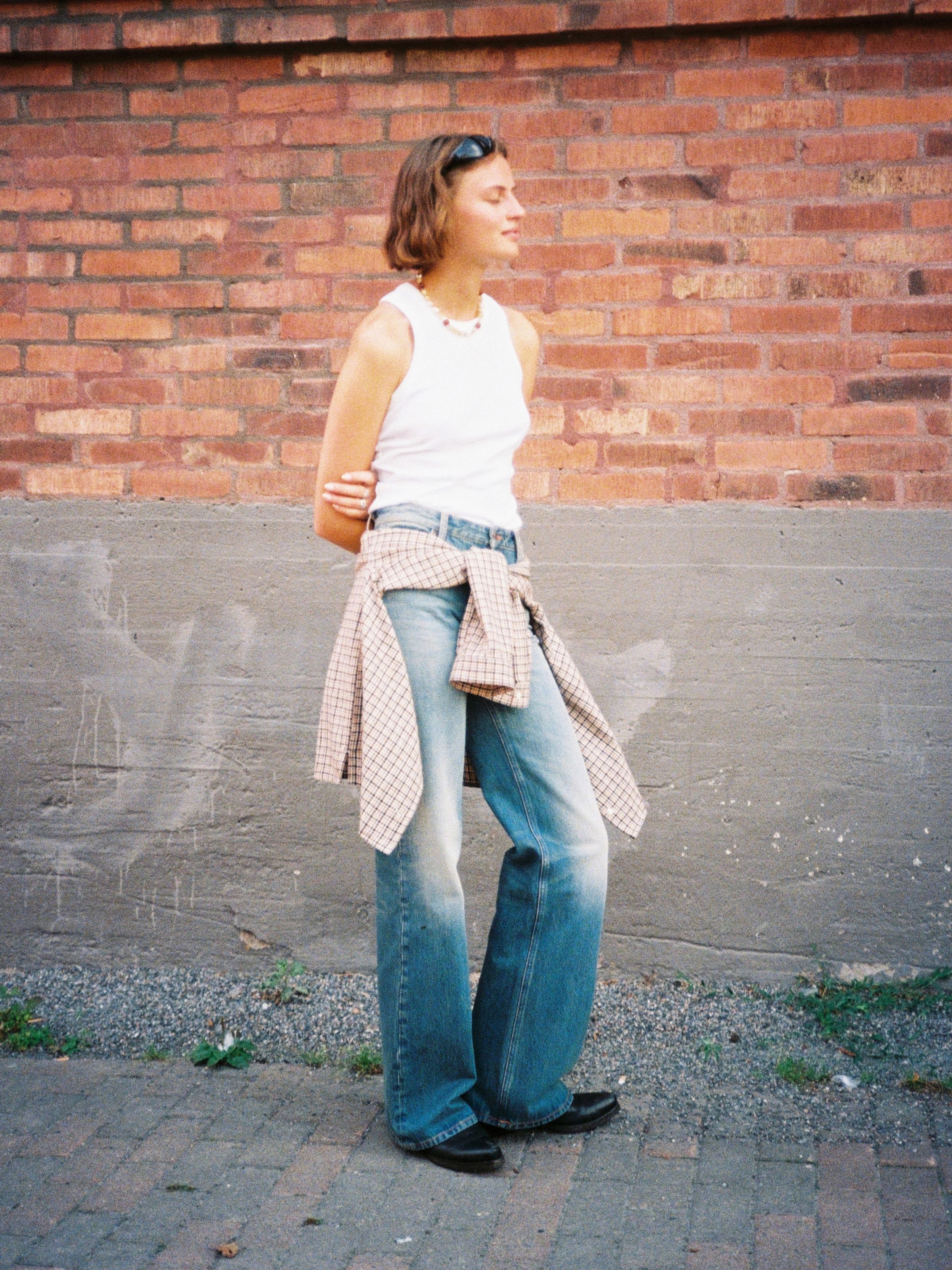 Nudie Jeans Wide Heidi Golden Drift, a women's wide leg jean worn by a model in an outdoor setting.