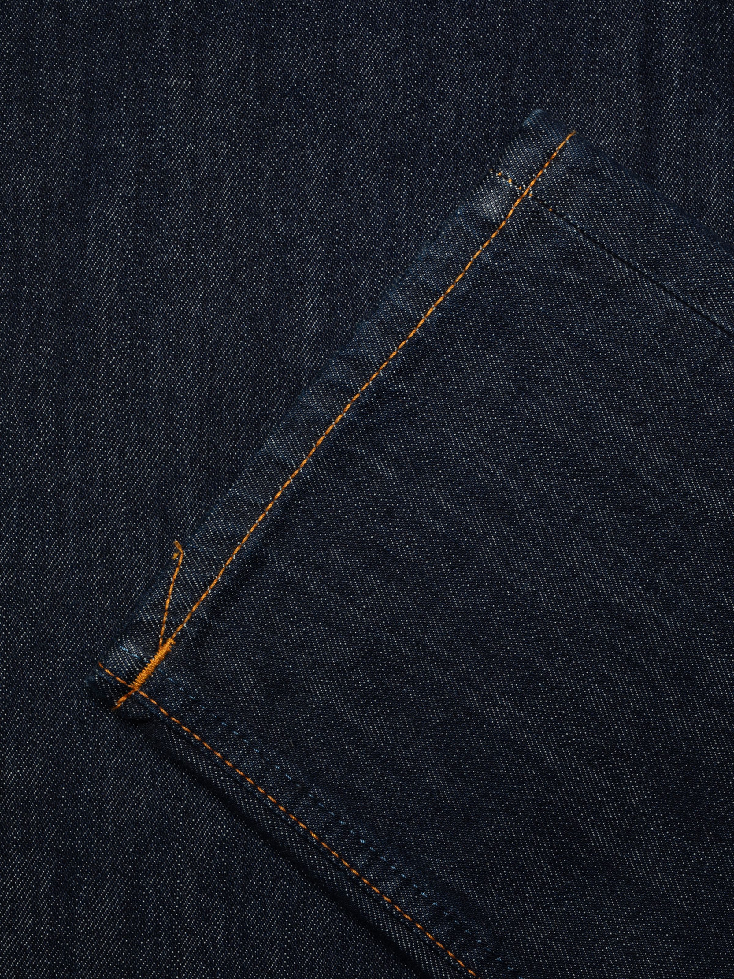 Nudie Jeans Rad Rufus in Blue One Wash, close-up detail of the deep blue denim and contrasting orange stitching.