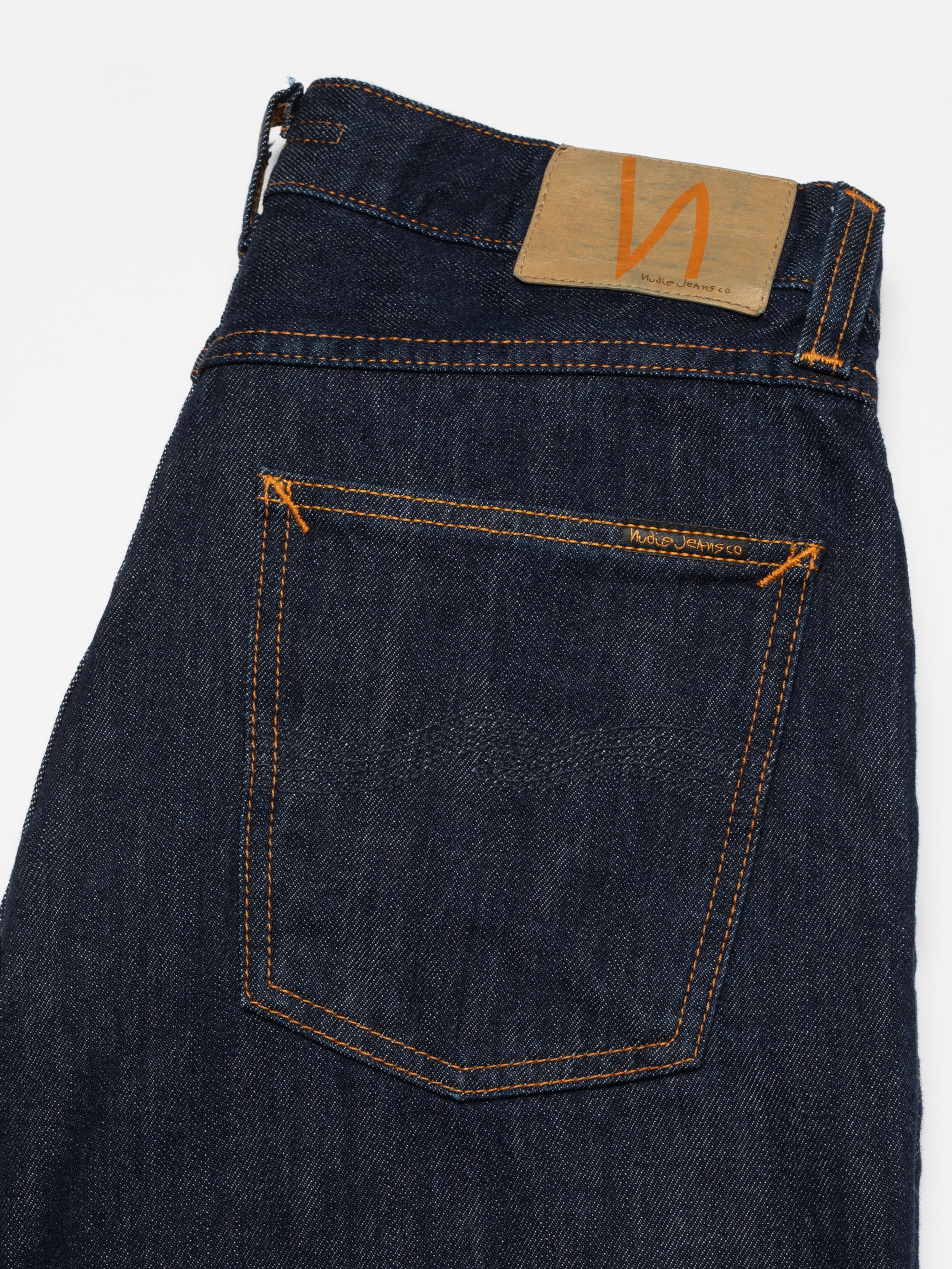 Nudie Jeans Rad Rufus in Blue One Wash, a close-up shot of the back pocket and jacron patch.