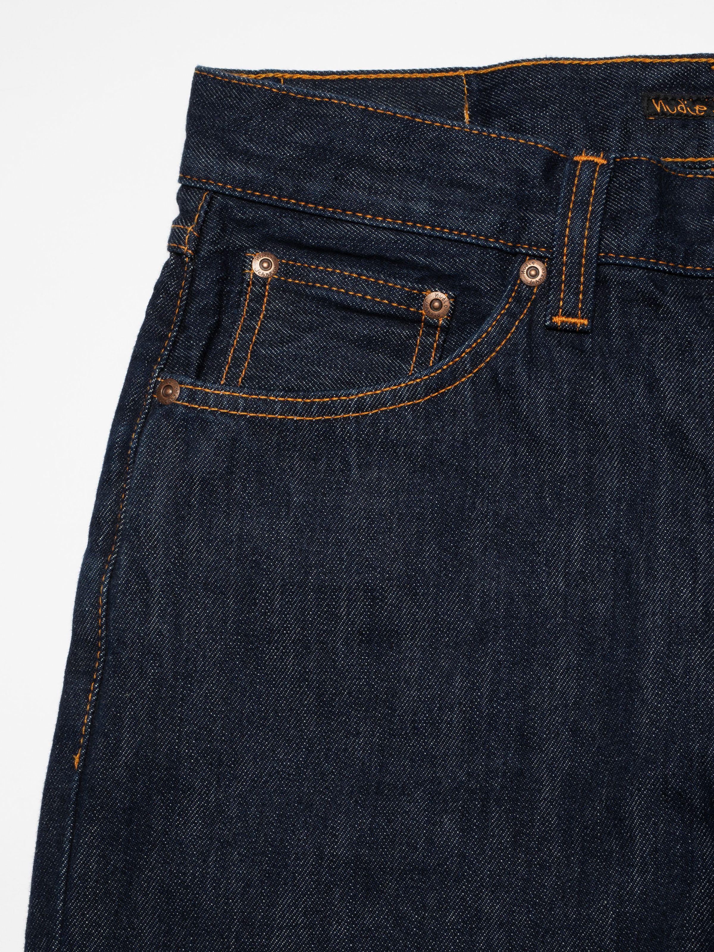 Nudie Jeans Rad Rufus in Blue One Wash, close-up of the front pocket with copper rivets and orange stitching.
