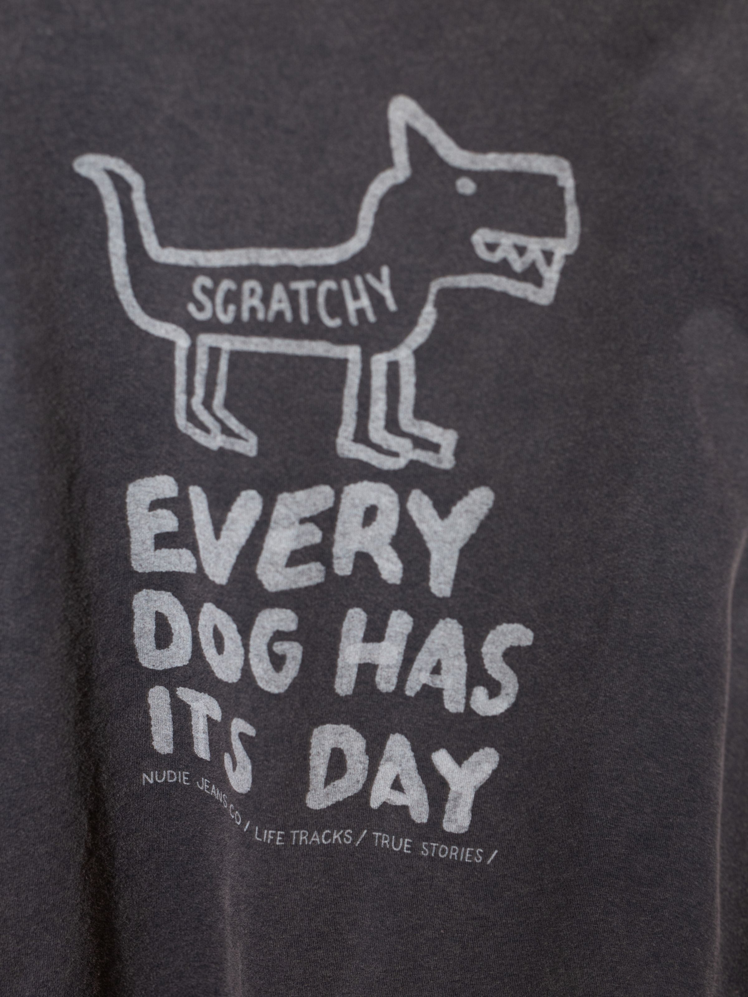 Nudie Jeans Koffe Scratched Tracks T-Shirt in Antracite, a men's t-shirt, shown in a close-up of the chest print.