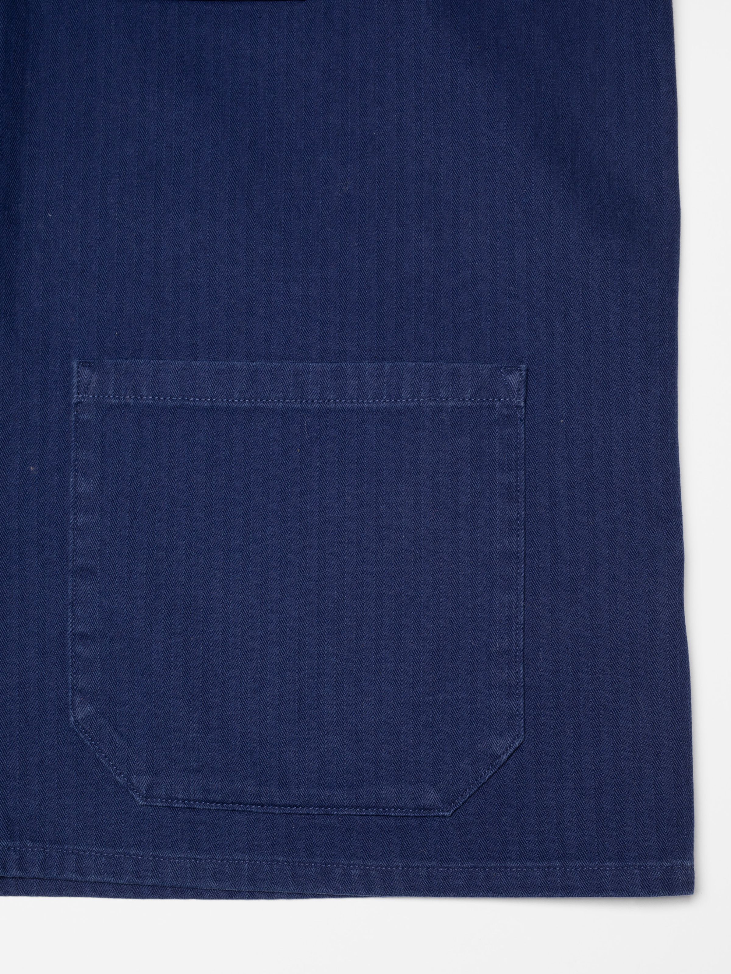 Nudie Jeans Buddy Chore Jacket Herringbone Deep Blue, a men's regular fit jacket, showing a close-up of a front pocket.