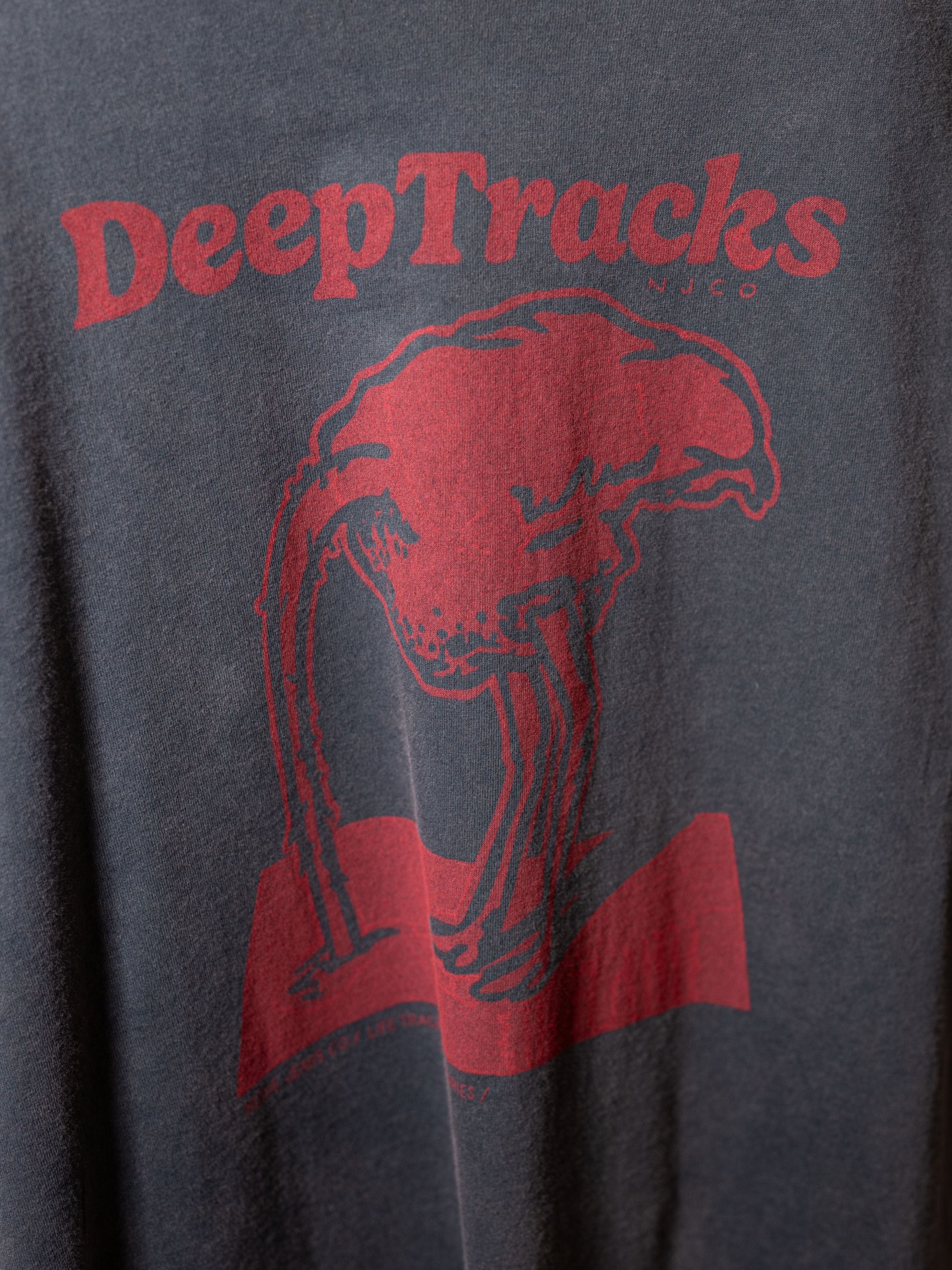 Nudie Jeans Roy Deep Tracks T-Shirt in Antracite, a men's t-shirt, showing a close-up of the red graphic on the chest.