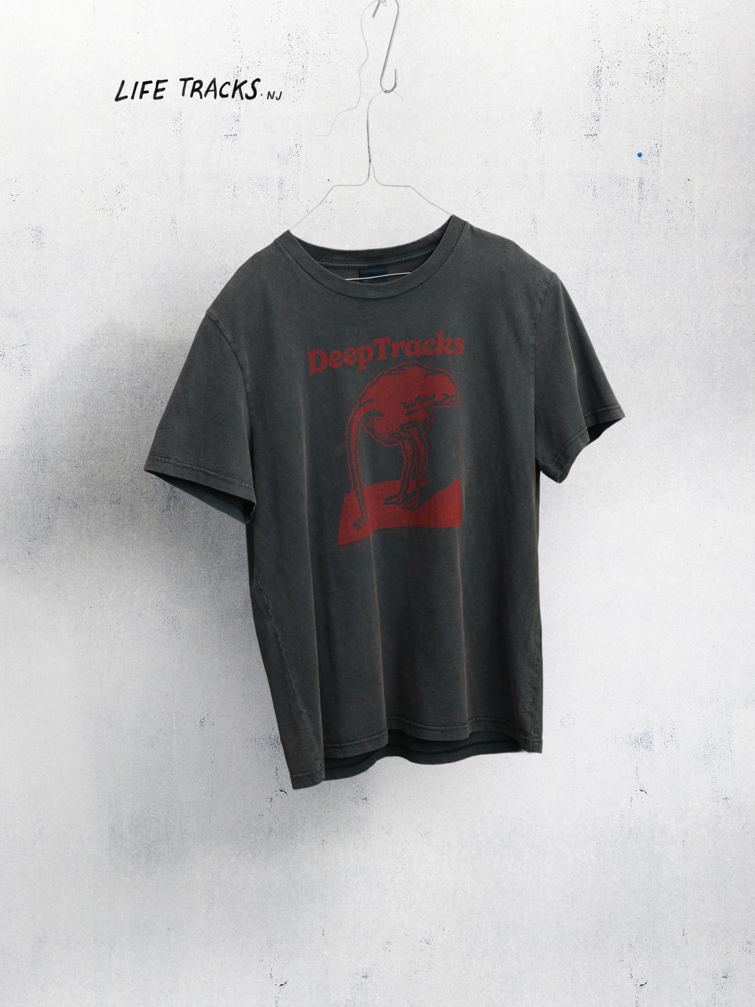 Nudie Jeans Roy Deep Tracks T-Shirt, a men's regular fit t-shirt in Antracite, shown hanging on a hanger.