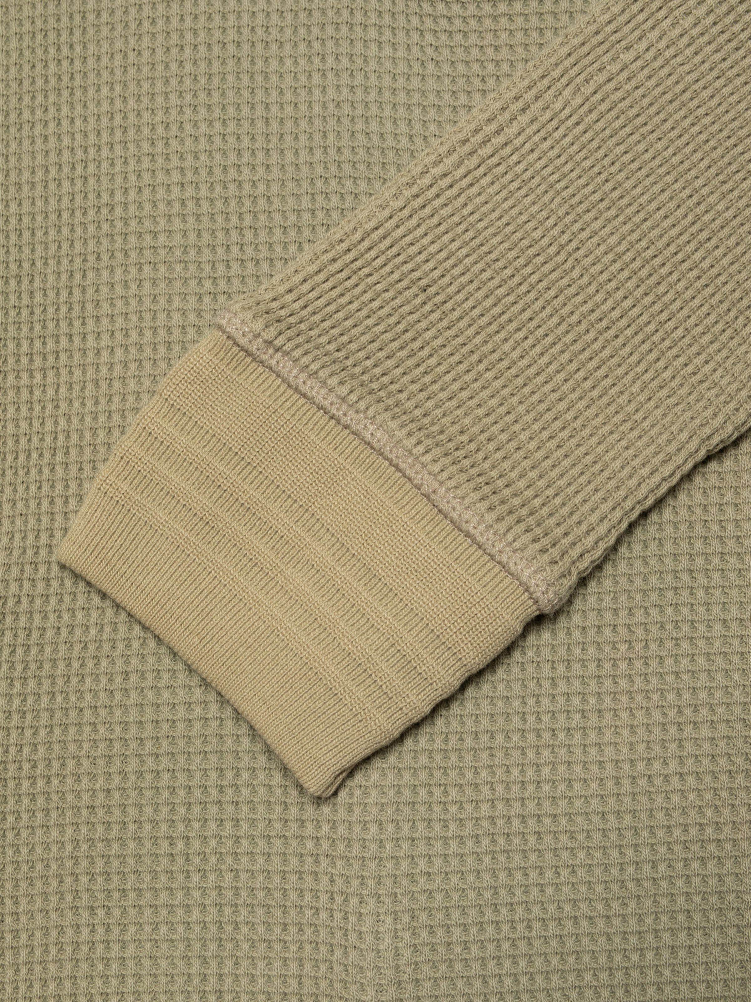 Nudie Jeans LS Henley Waffle T-Shirt in Desert, showing a close-up of the waffle knit sleeve and ribbed cuff.