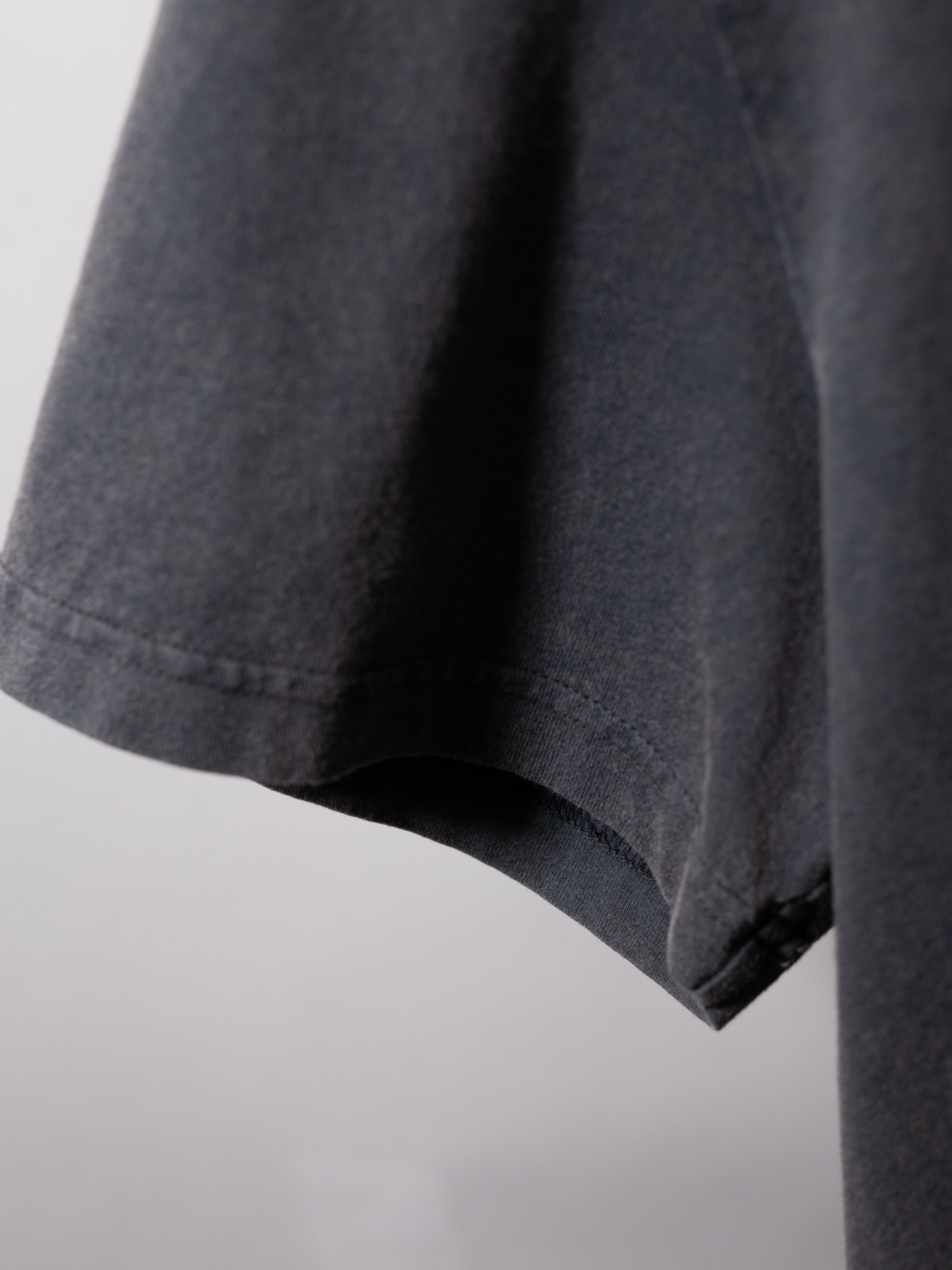 Nudie Jeans Roy Pale Tracks T-Shirt in Antracite, a men's t-shirt showing a close-up detail of the sleeve.