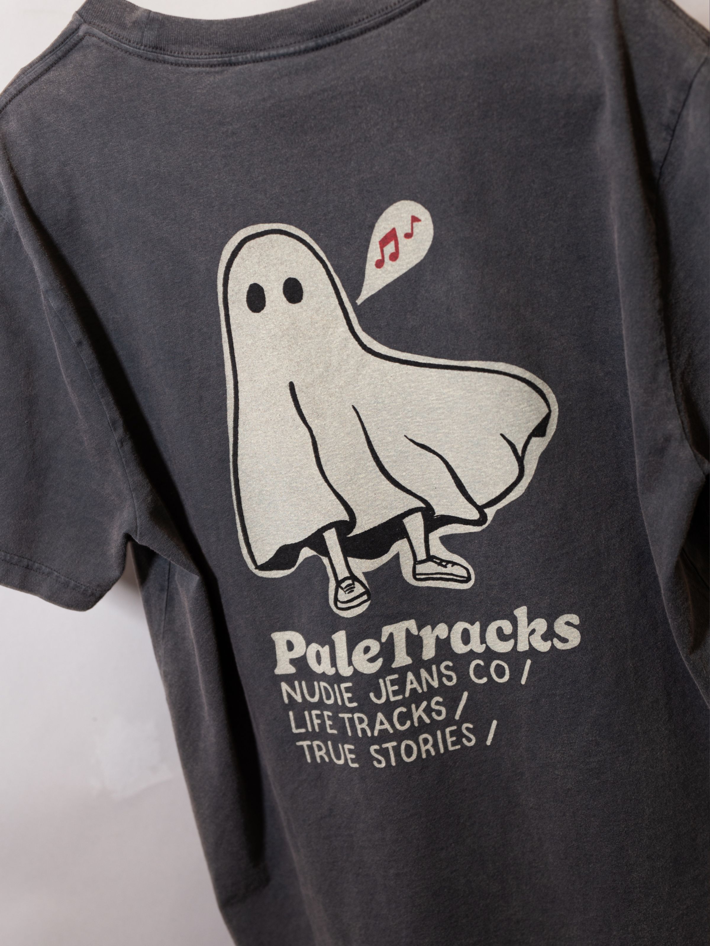 Nudie Jeans Roy Pale Tracks T-Shirt in Antracite, a close-up shot of the graphic print on the back.