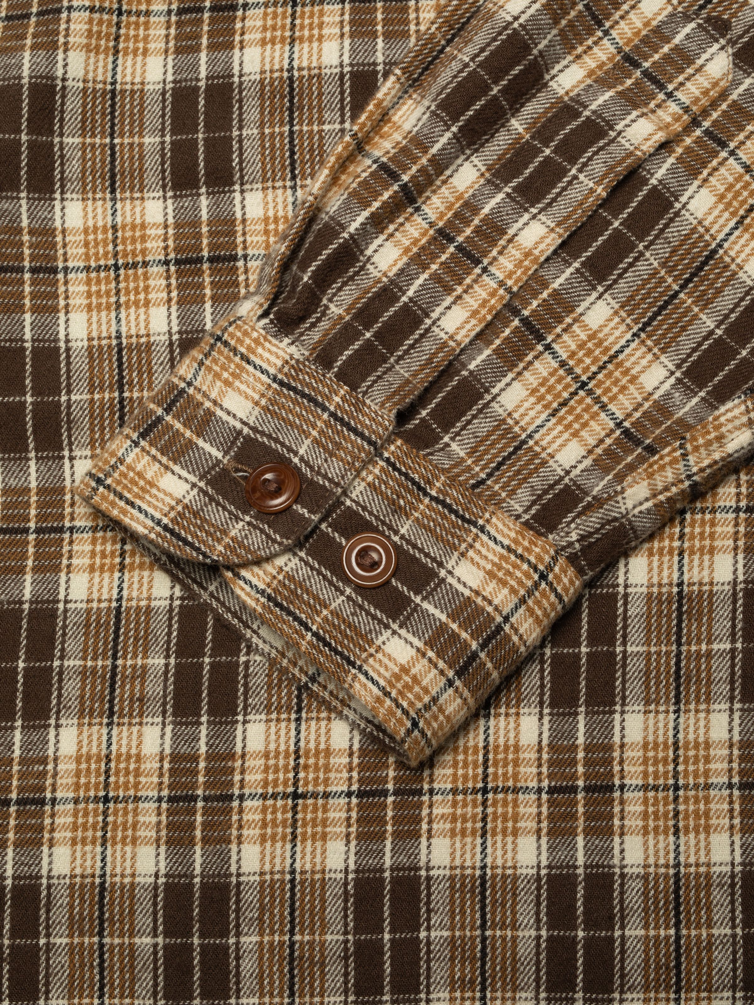 Nudie Jeans Julian Worker Shirt Check in Brown, a men's plaid shirt, showing a close-up of the sleeve cuff.