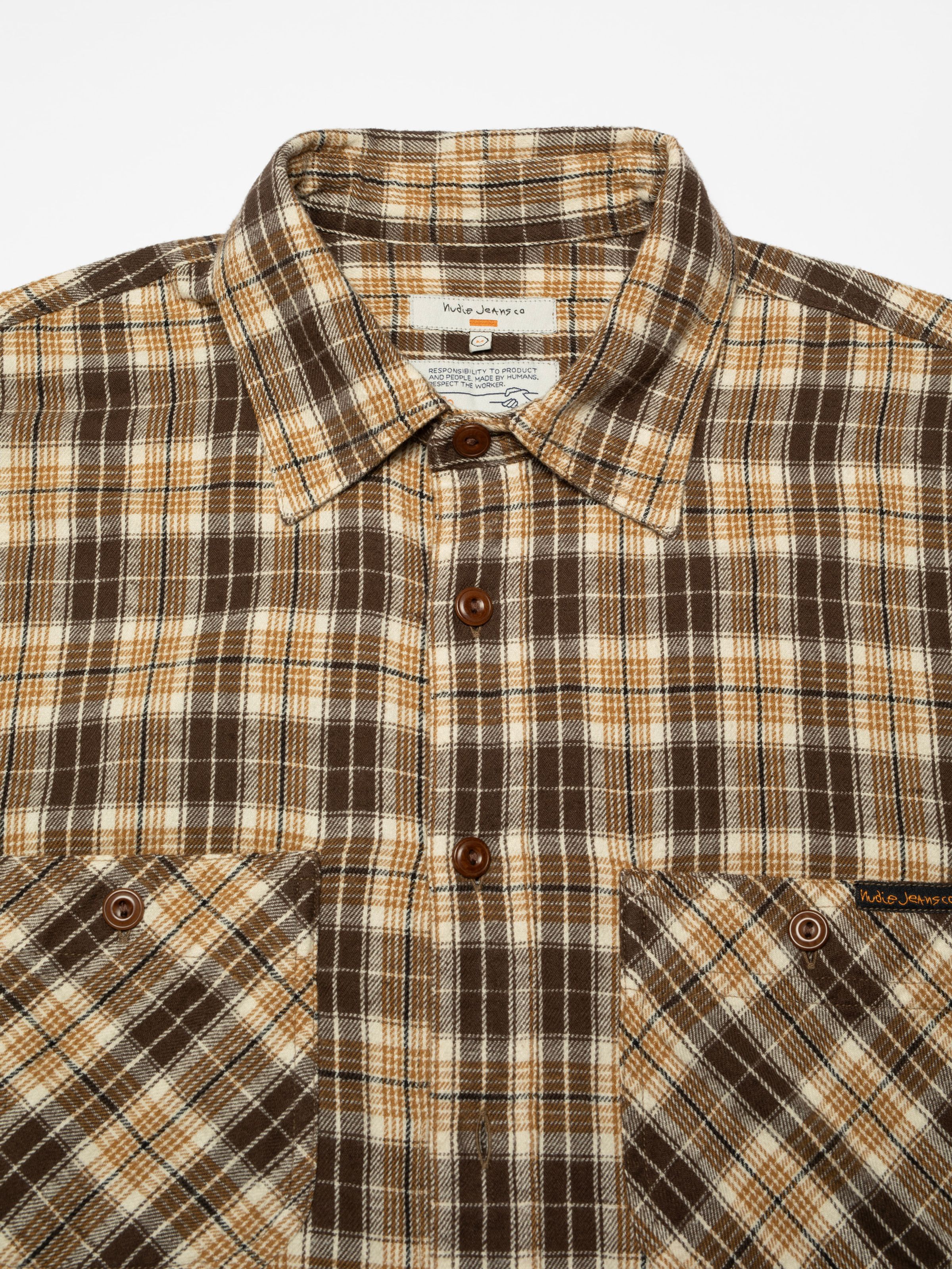 Nudie Jeans Julian Worker Shirt Check Brown, a men's brown check shirt, shown laid flat in a close-up of chest and collar.