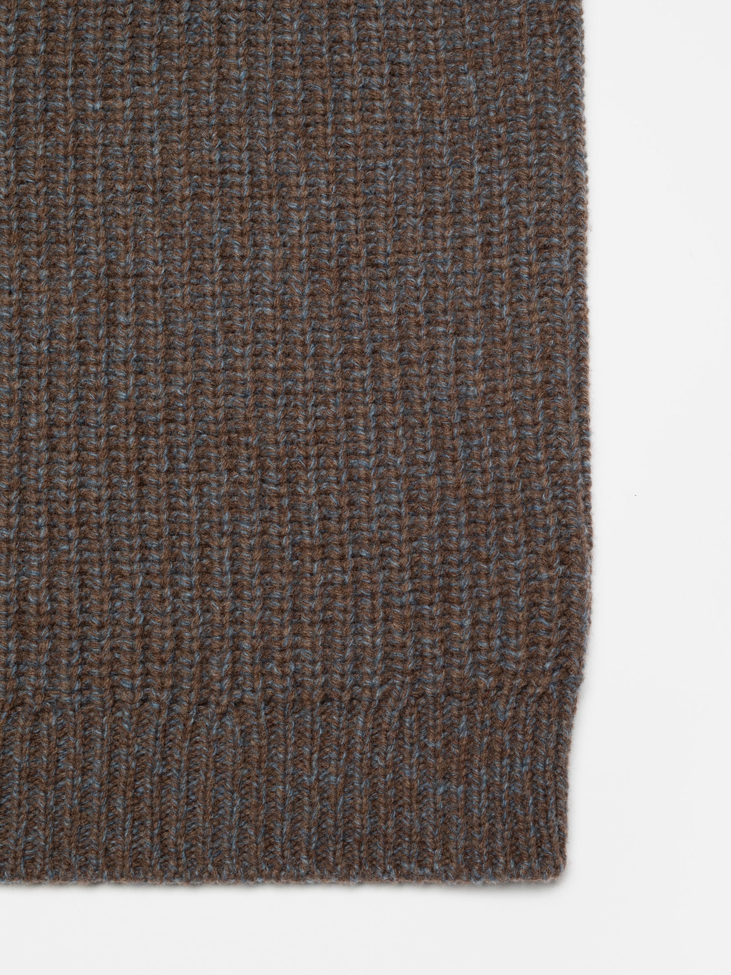 Nudie Jeans August Chunky Crew Neck Knit, a men's brown wool sweater showing a close-up of the rib stitch fabric.