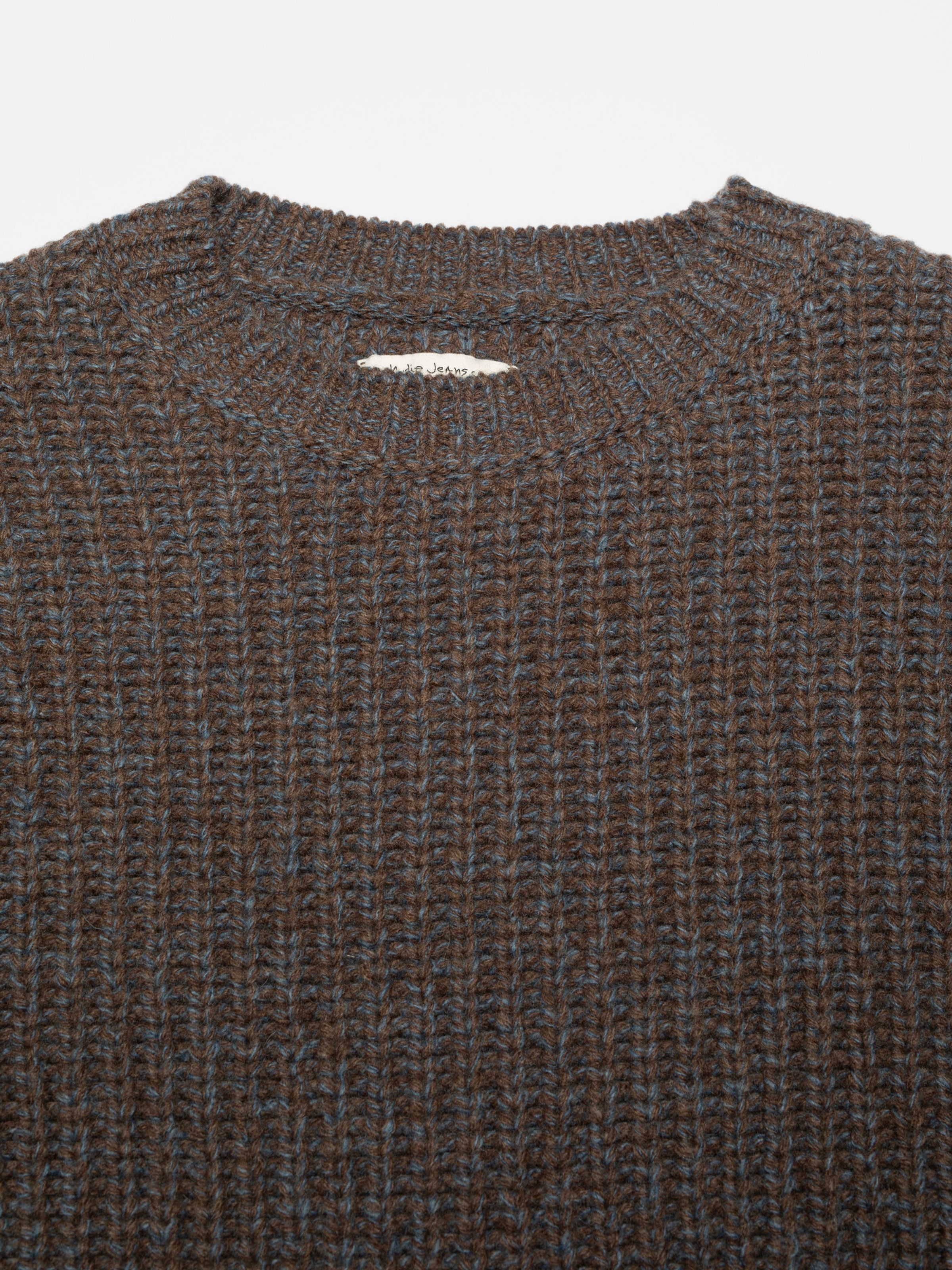 Nudie Jeans August Chunky Crew Neck Knit in Brown, a men's regular fit sweater, shown in a close-up of the crew neck.