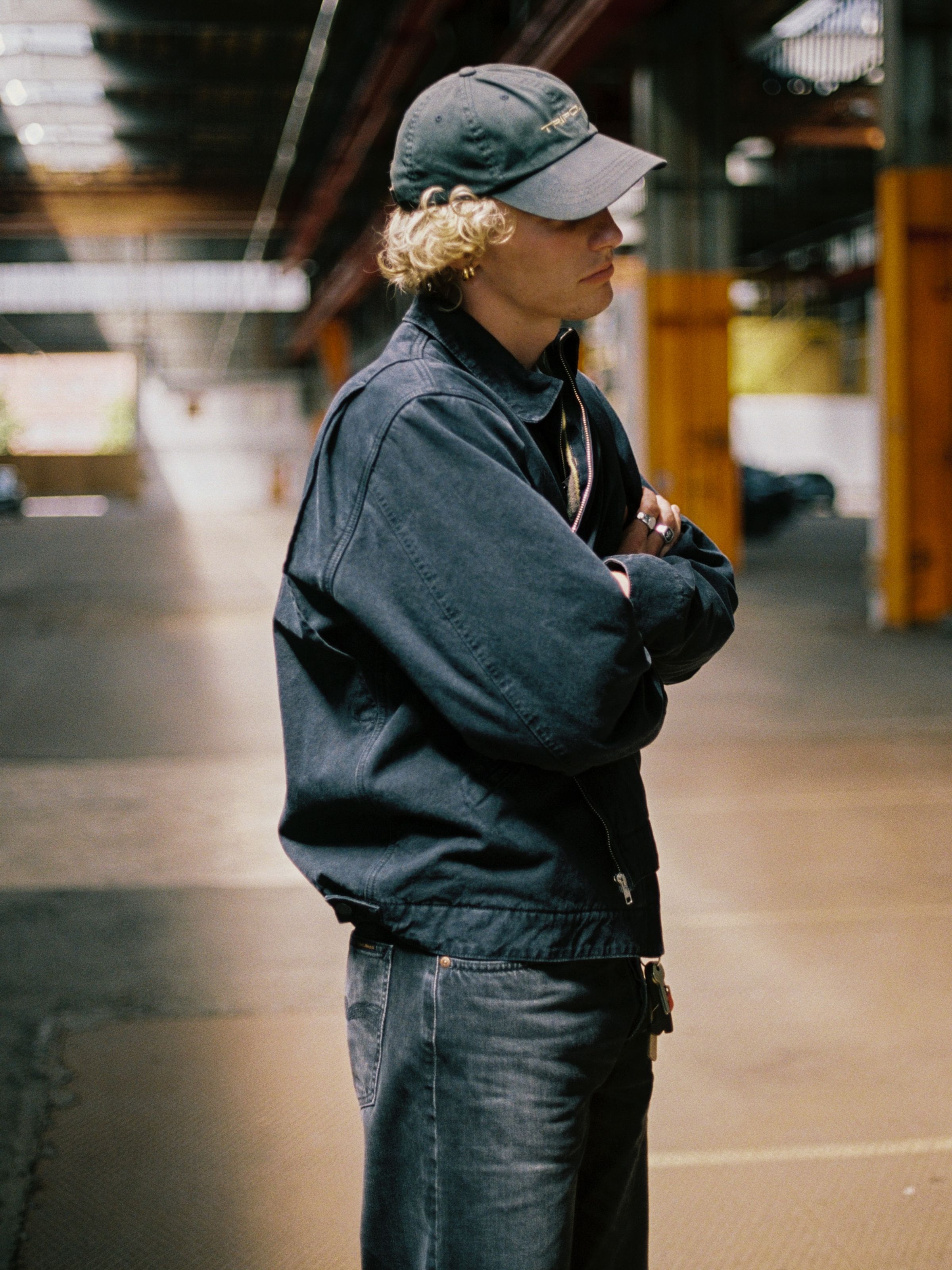 Nudie Jeans Blake Zip Jacket Duck Canvas, a men's black jacket worn by a model and shown from the side.
