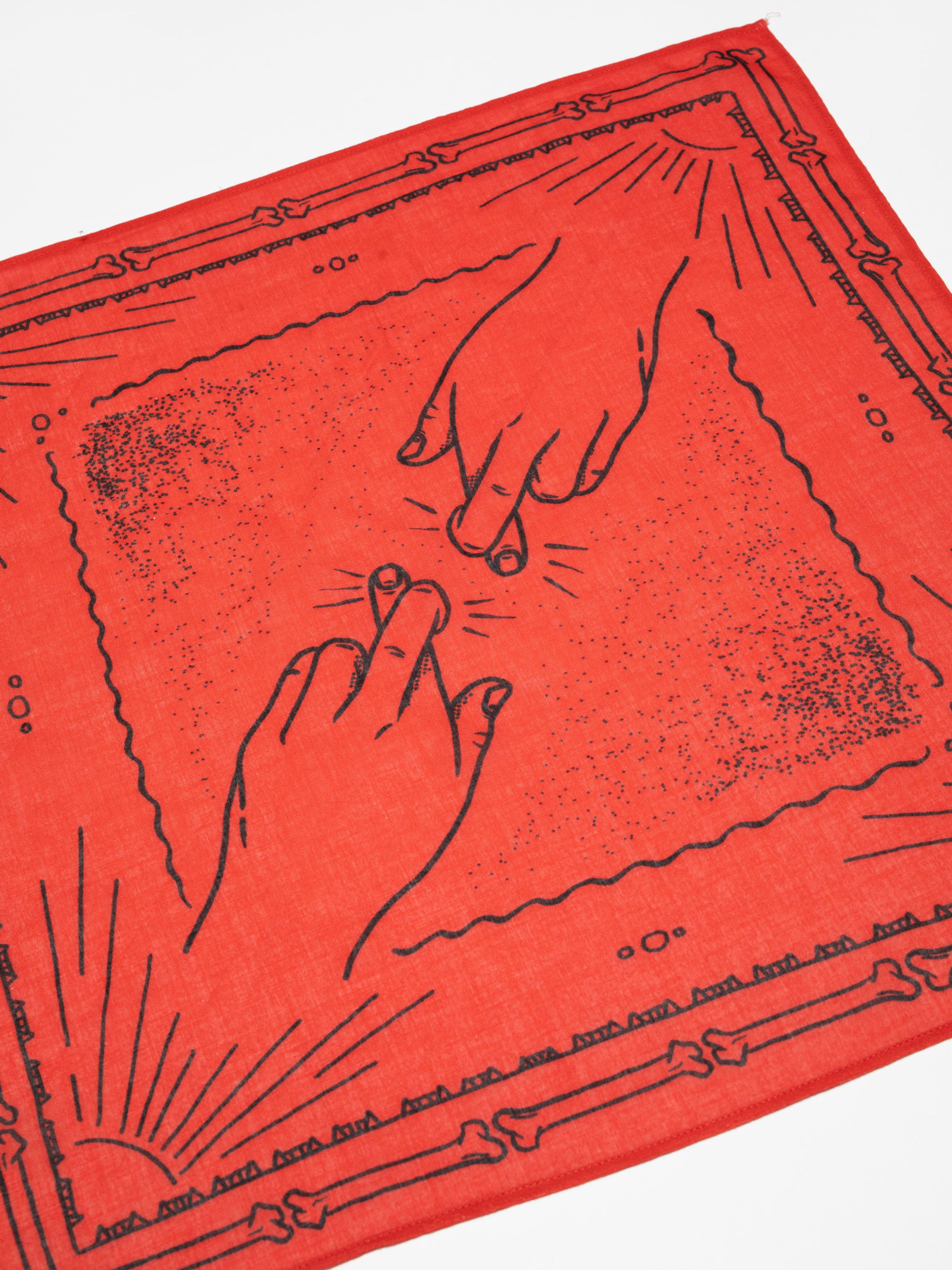 Nudie Jeans Ingrid Bandana in Double Cross Red, a unisex organic cotton scarf shown laid flat in a close-up shot.