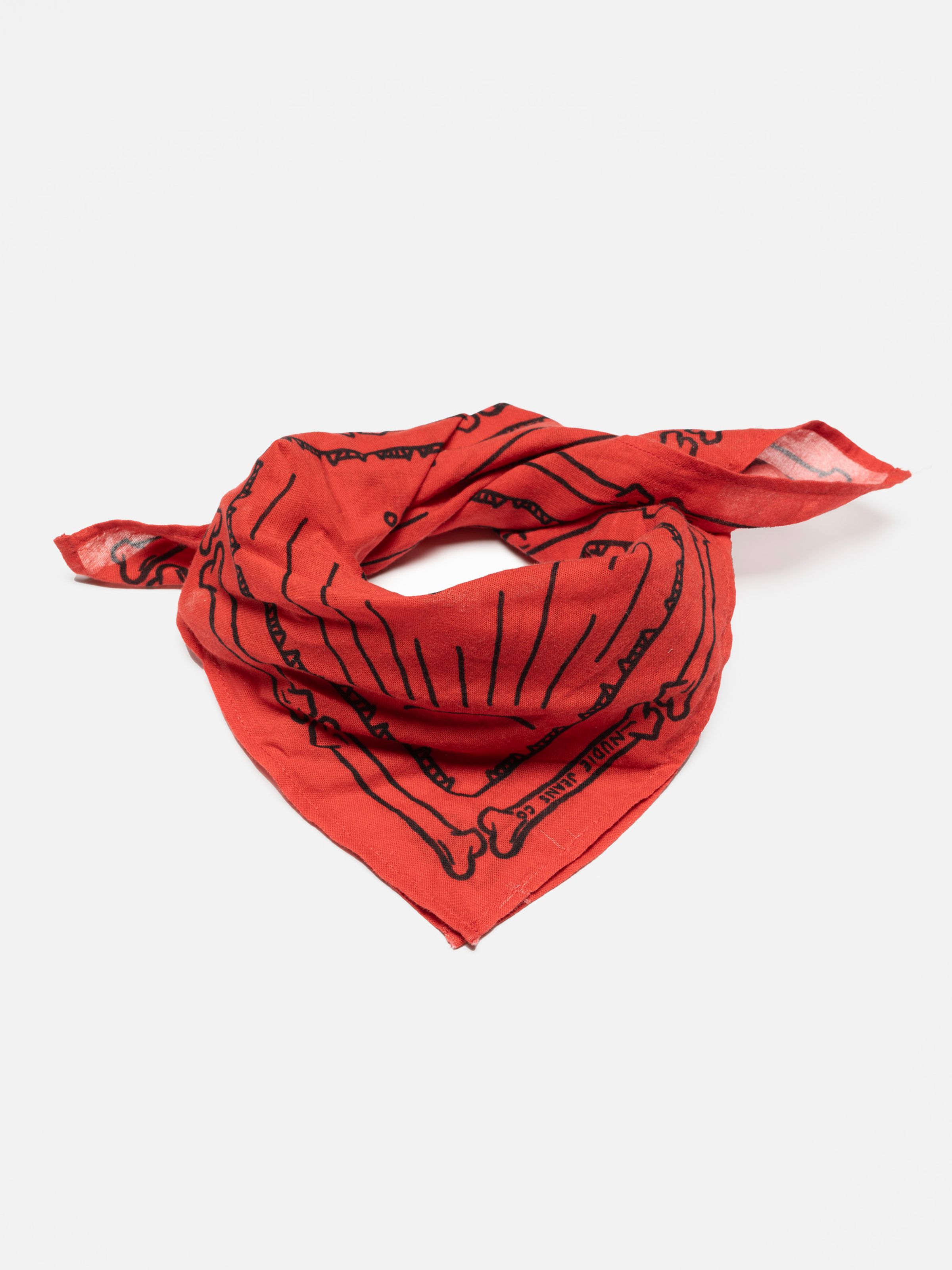 Nudie Jeans Ingrid Bandana in red, a unisex organic cotton bandana with a black print, shown tied in a knot.
