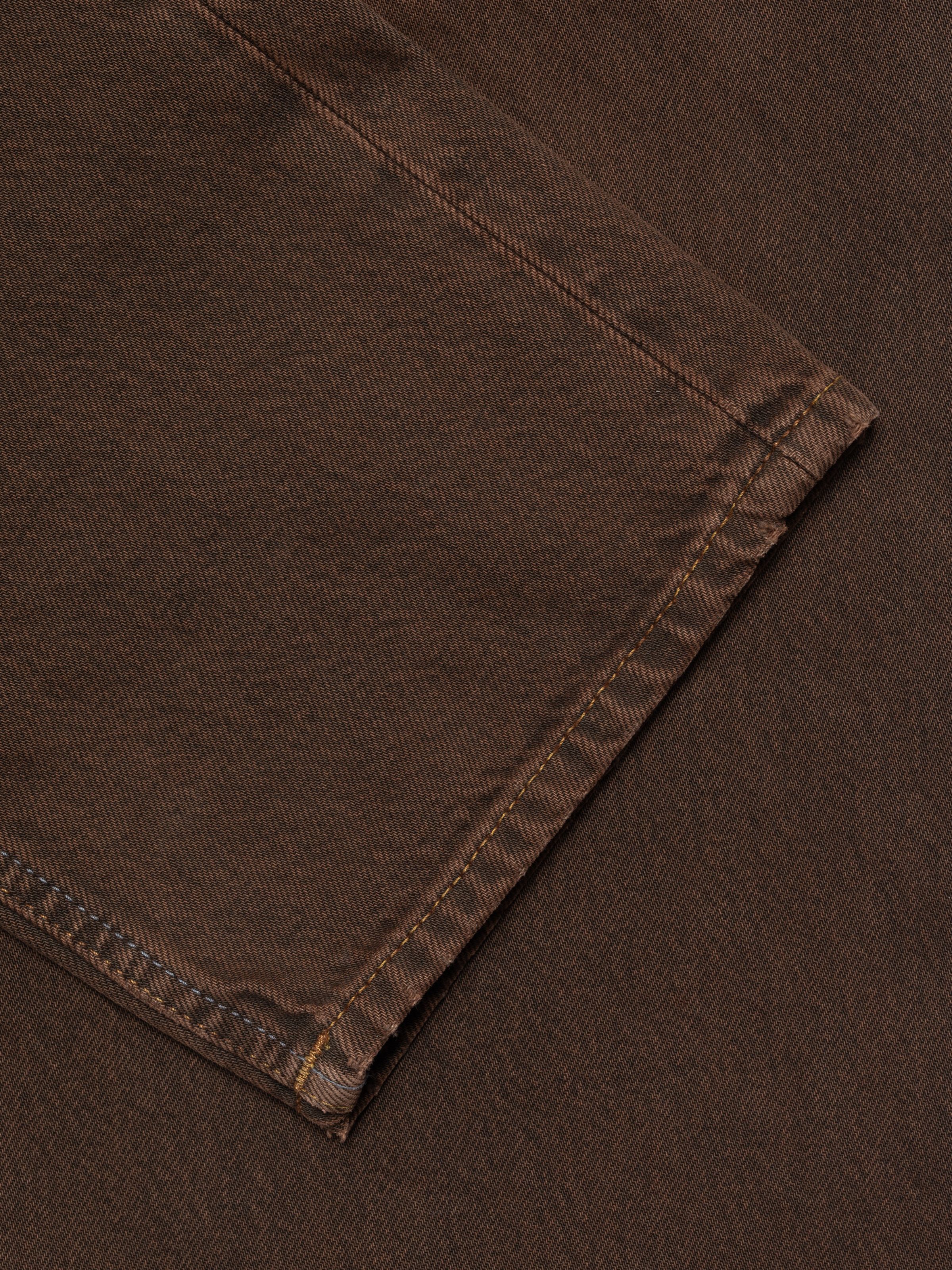 Nudie Jeans Rad Rufus Espresso Bernardini, close-up of the leg opening and hem on these brown organic cotton jeans.