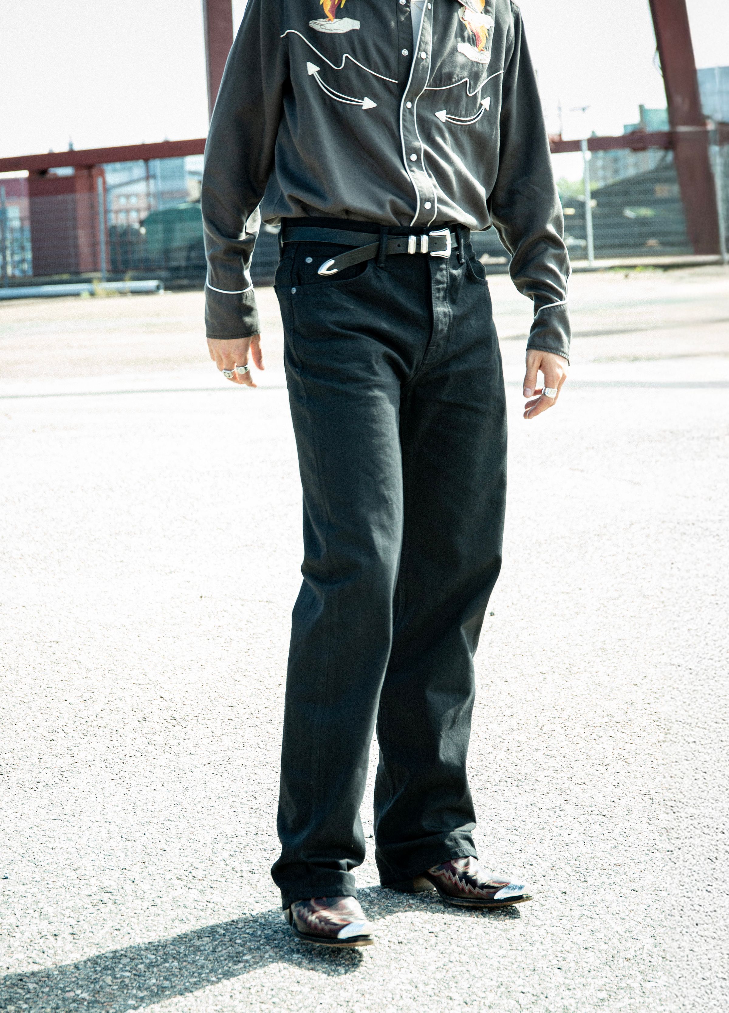 Nudie Jeans Tuff Tony in Black Water, a men's loose fit jean worn by a model and shown from the front.