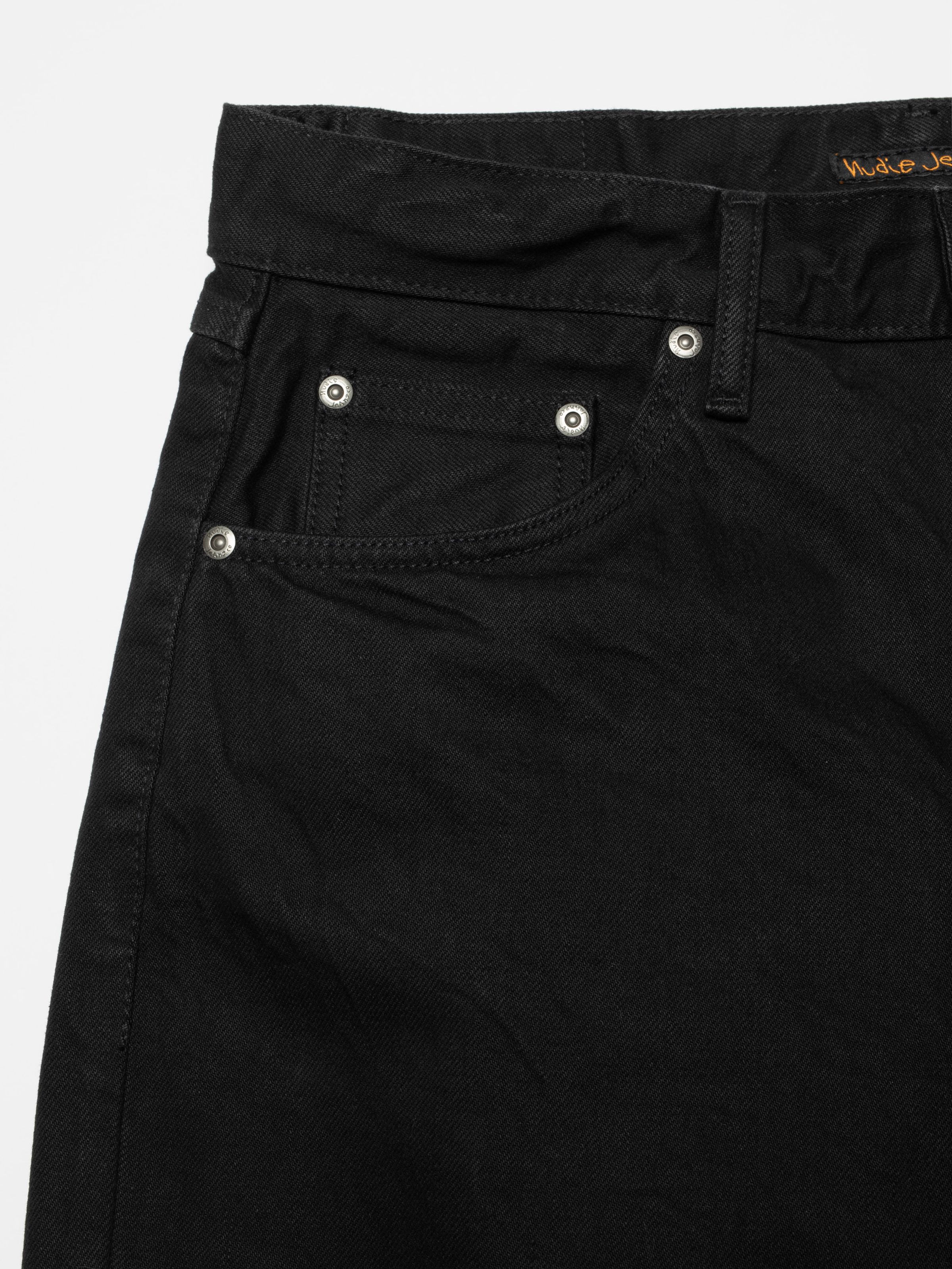 Nudie Jeans Tuff Tony Black Water, a pair of men's loose fit jeans in black denim, shown in a close-up of the front pocket.