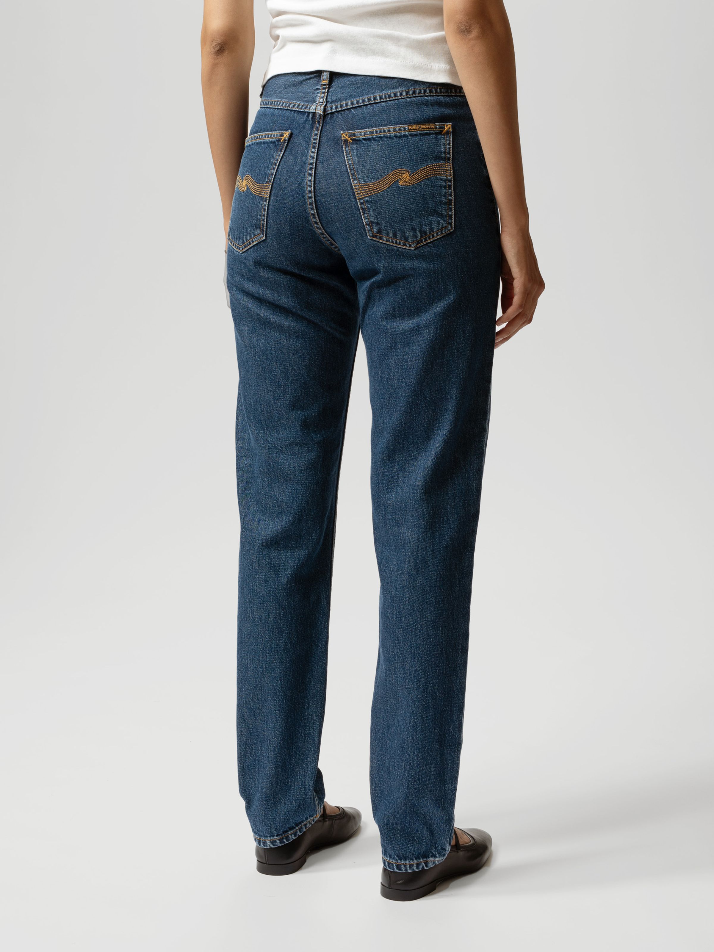 Nudie Jeans Breezy Britt Evening Jazz, a pair of women's regular tapered fit jeans, worn by a model and shown from the back.