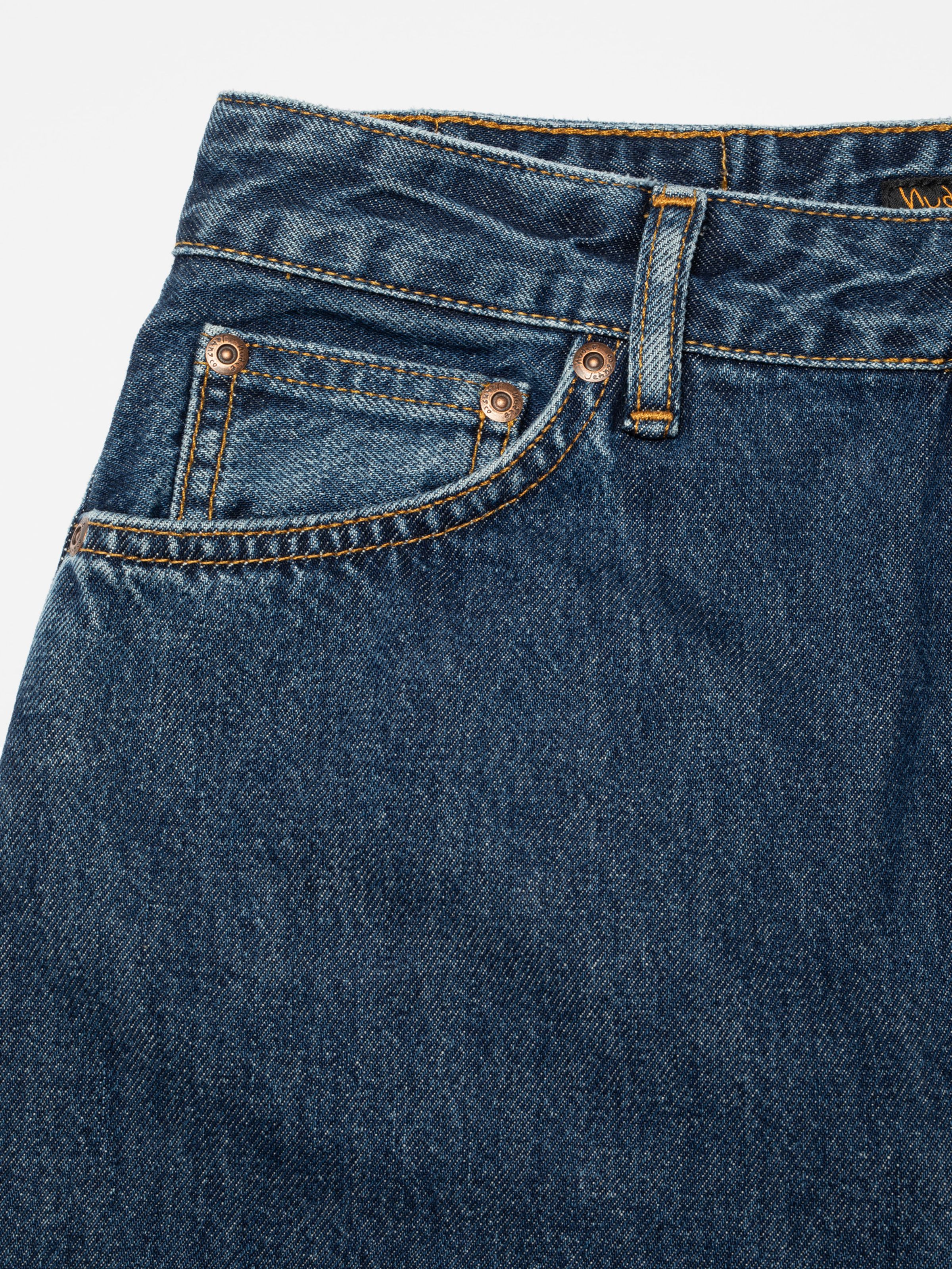 Nudie Jeans Breezy Britt in Evening Jazz, a women's regular tapered jean, shown in a close-up detail of the front pocket.