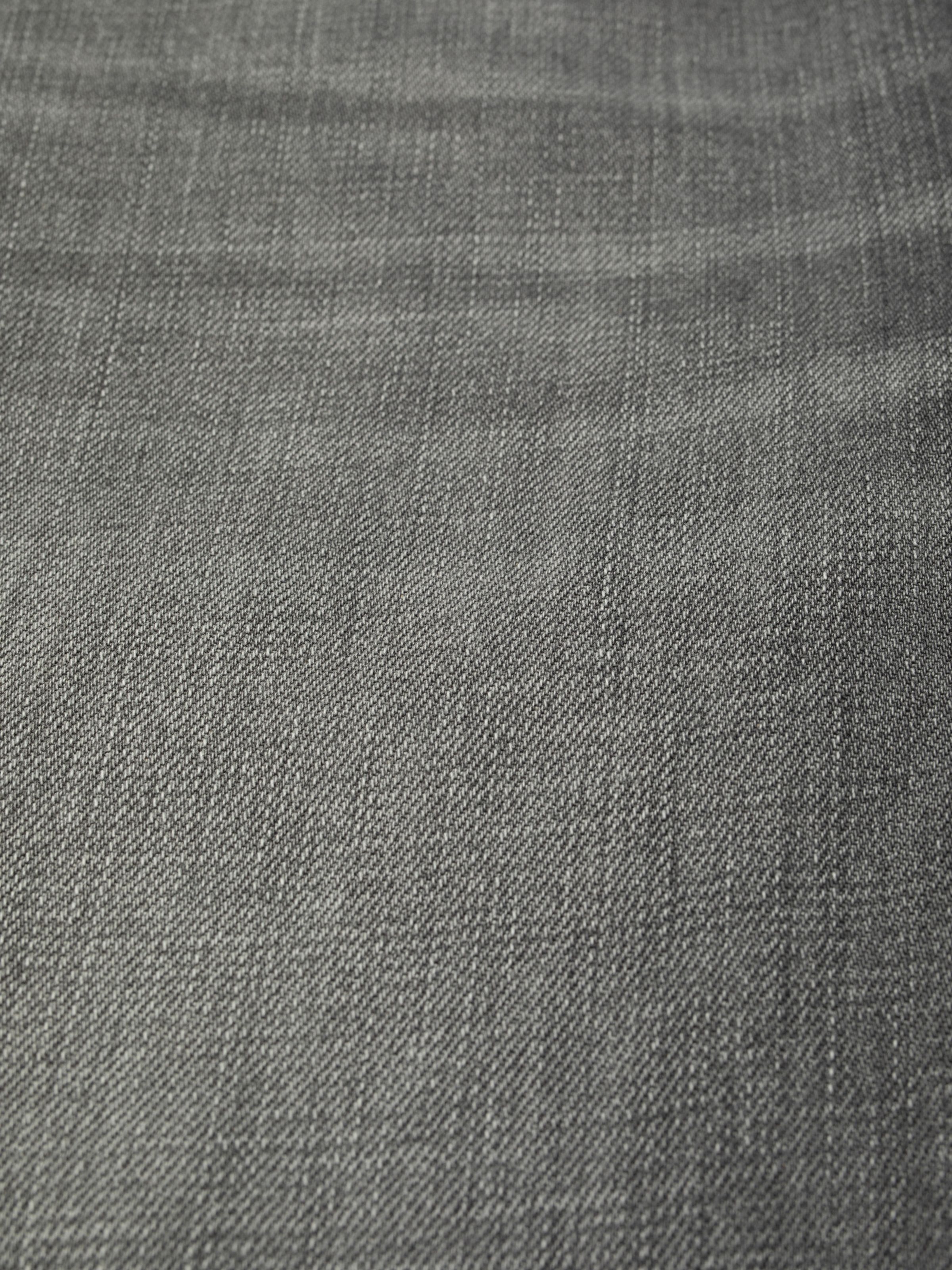 Nudie Jeans Lofty Lo Foggy Grey, a close-up shot of the foggy grey rigid denim fabric.