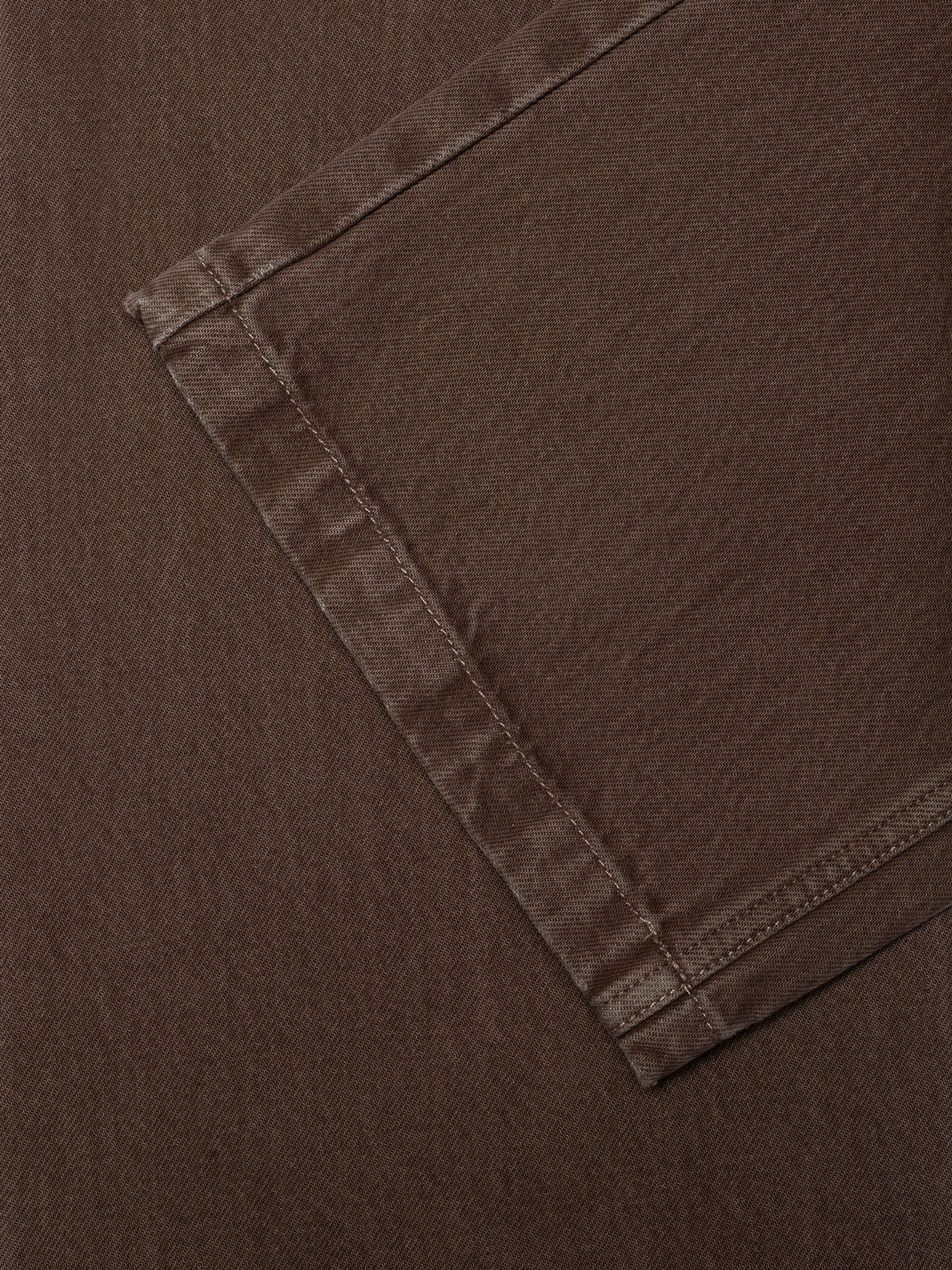 Nudie Jeans Asta Workwear Pants Brown, women's loose fit pants in brown denim, shown in a close-up of the leg hem.