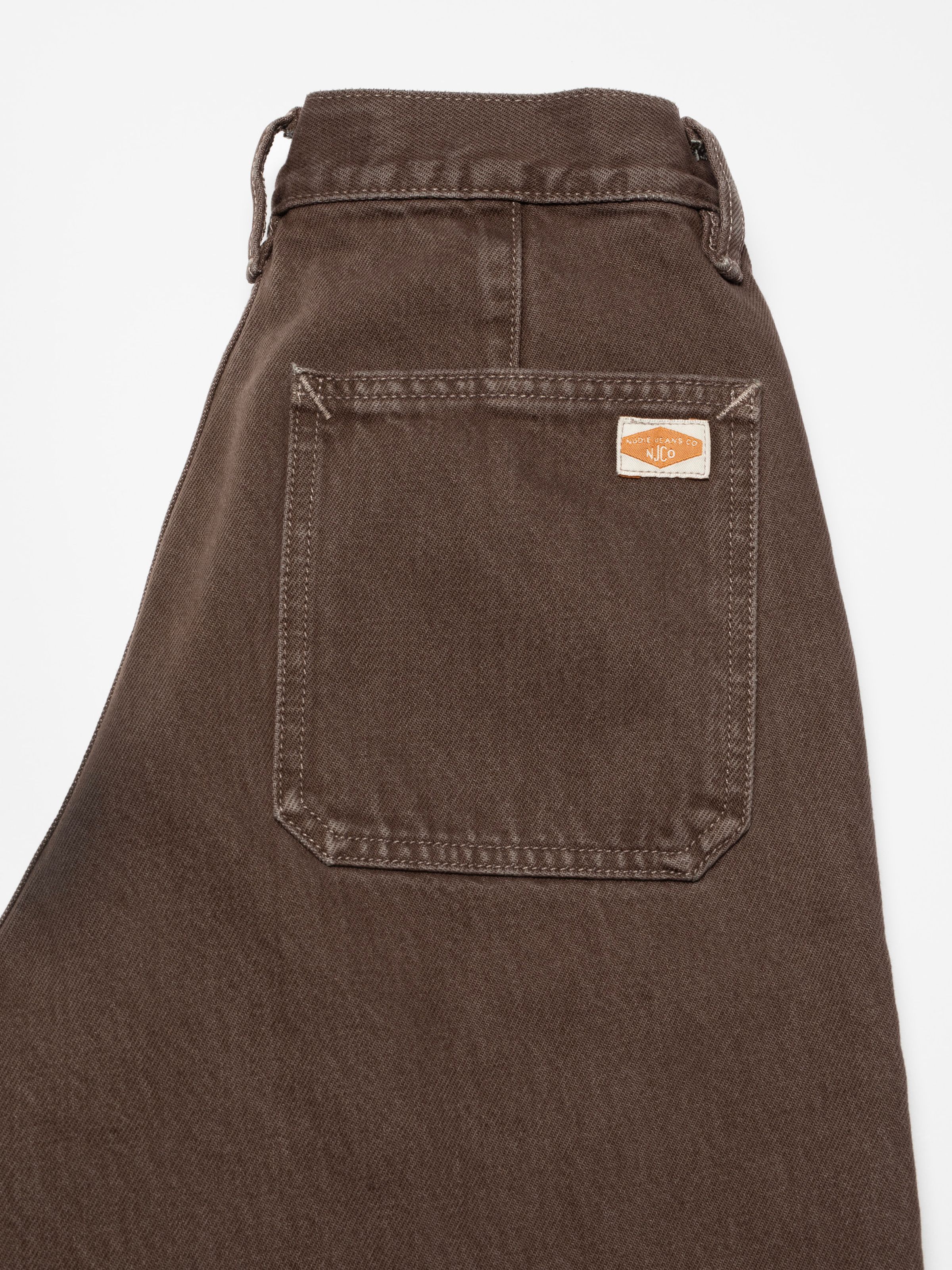 Nudie Jeans Asta Workwear Pants Brown, women's loose fit pants in brown denim, showing a close-up of the back pocket detail.