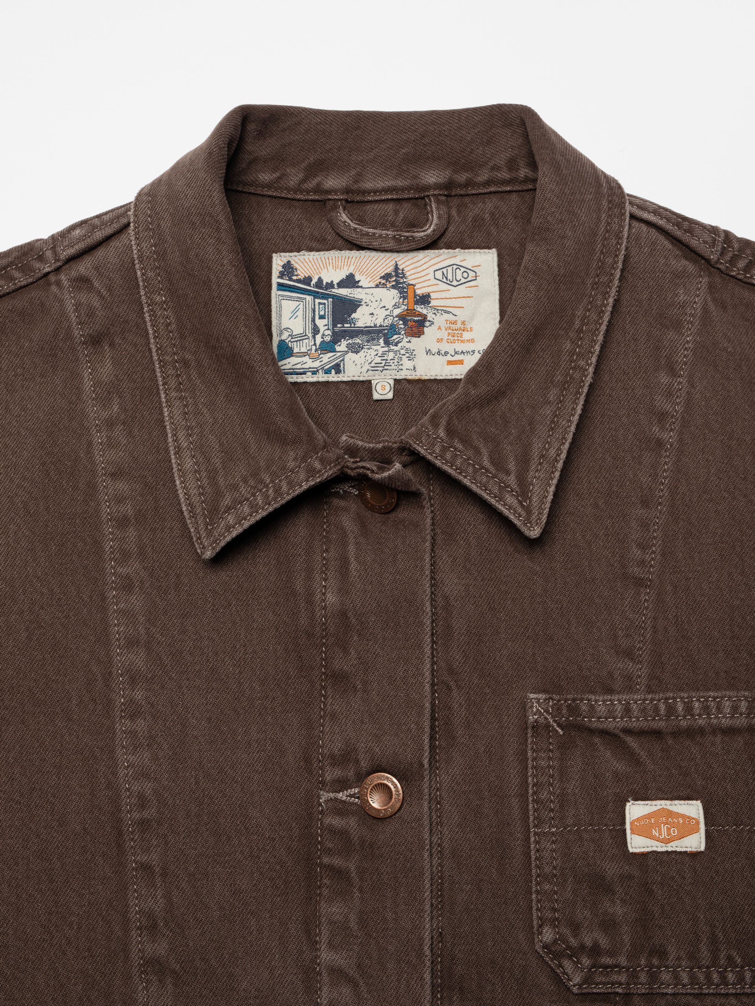 Nudie Jeans Ada Workwear Jacket Espresso, a women's brown denim jacket, showing a close-up of the collar and chest.