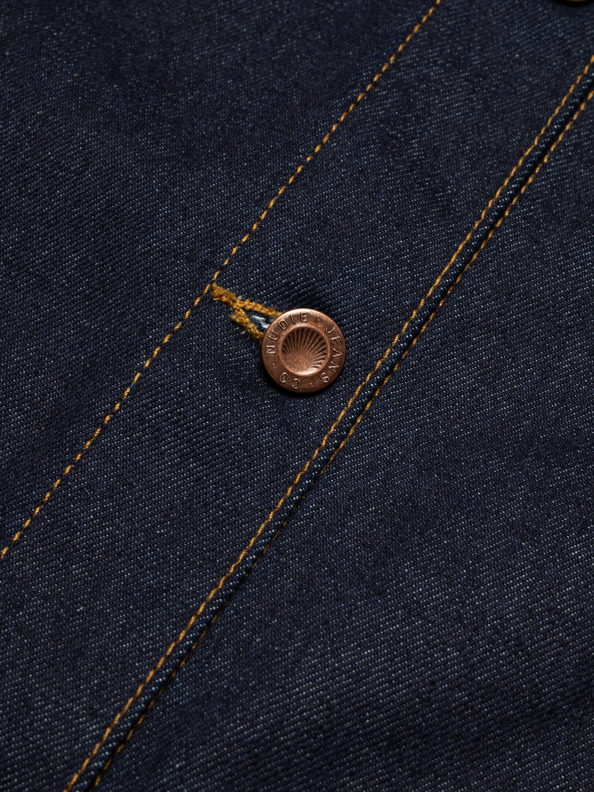 Nudie Jeans Kelly Western Jacket in Embroidery Blue, a women's denim jacket shown in a close-up of the copper button.