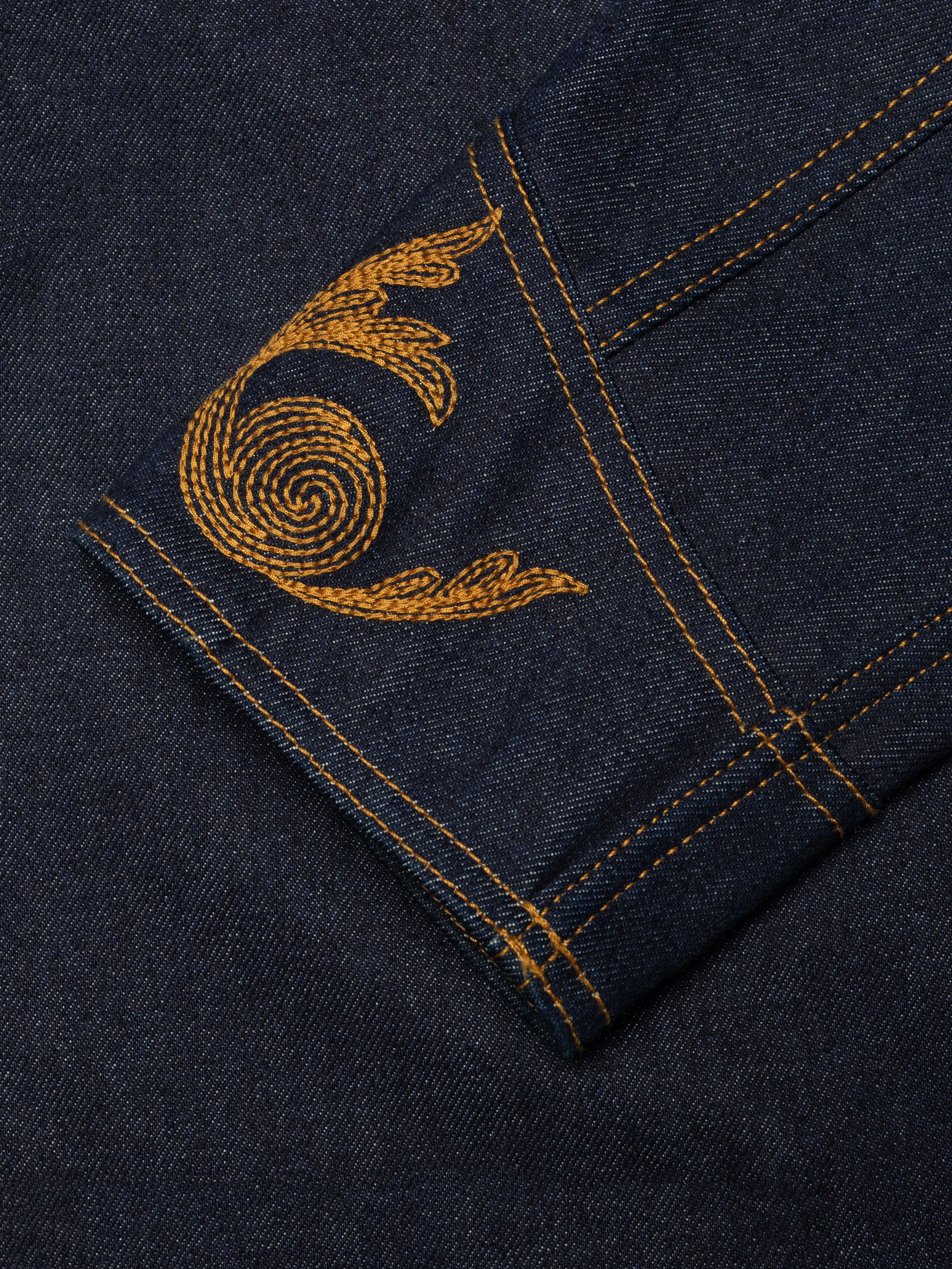 Nudie Jeans Kelly Western Jacket, a women's regular fit denim jacket in dry blue, showing a close-up of the cuff embroidery.