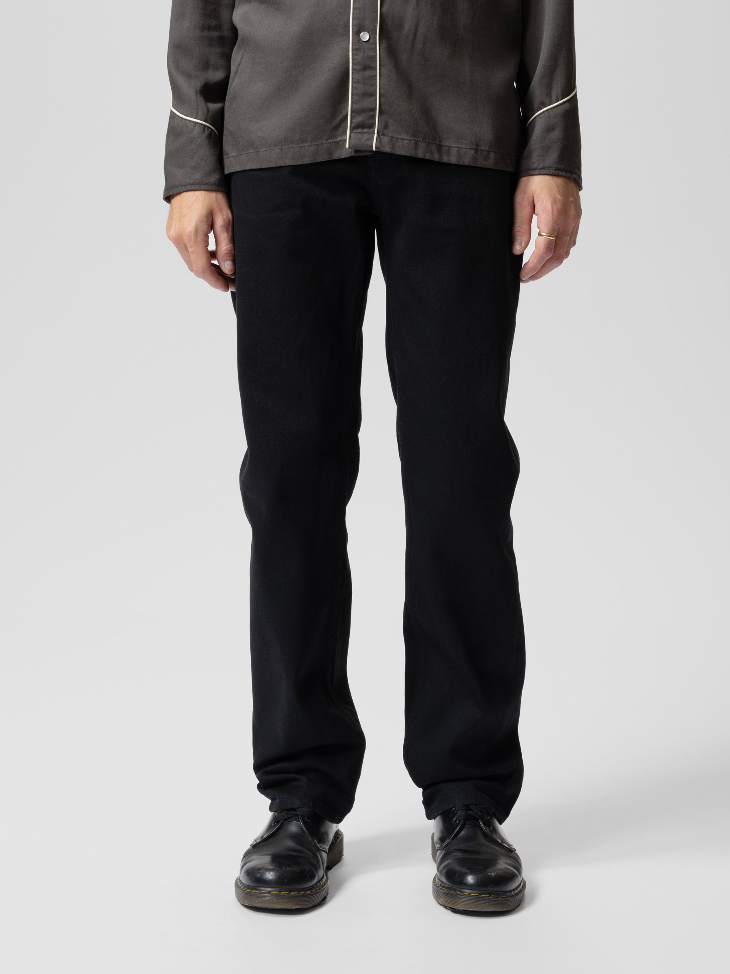 Nudie Jeans Rad Rufus Black Water, a men's regular fit jean worn by a model and shown from the front.