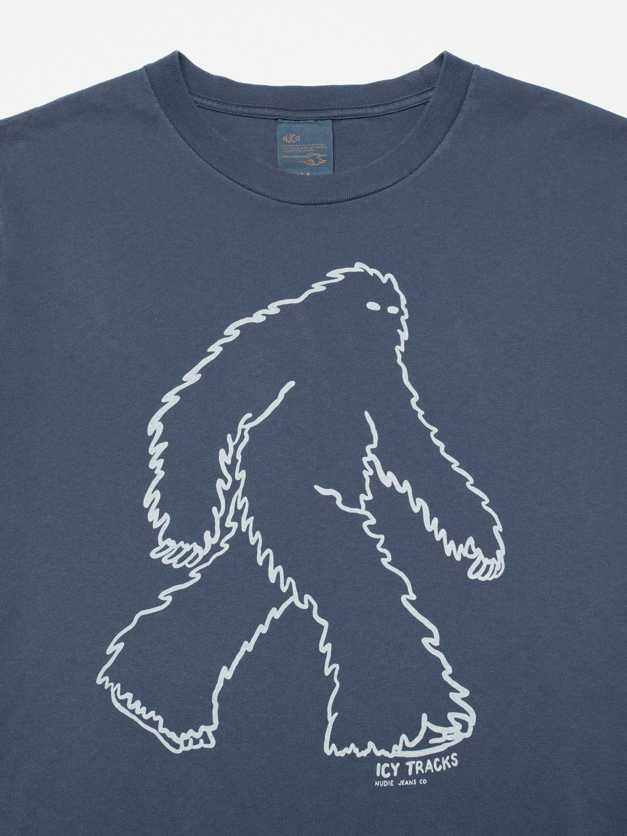 Nudie Jeans Roy Icy Tracks T-Shirt in dark blue, showing a close-up of the Sasquatch print on the chest.