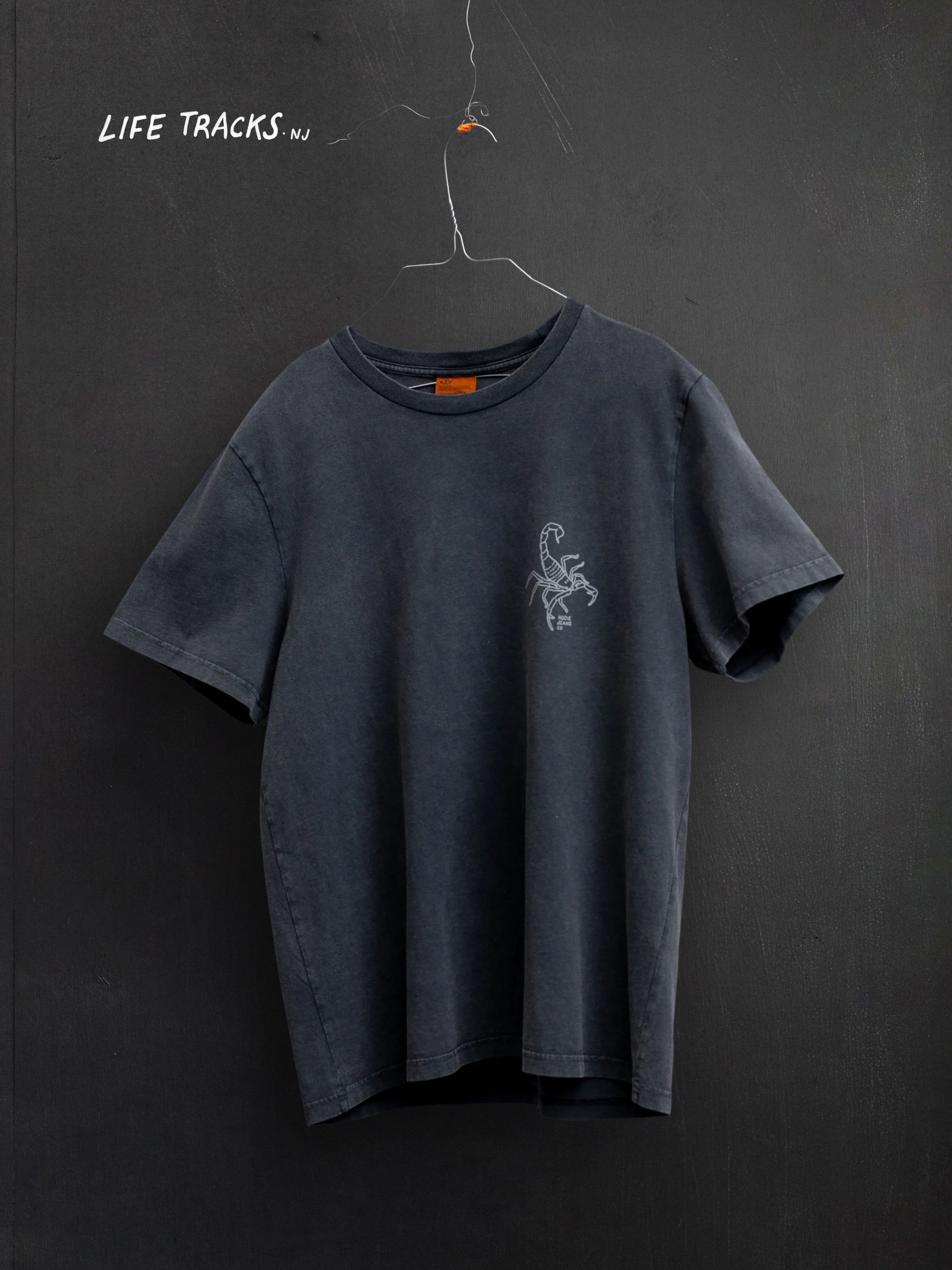 Nudie Jeans Roy Sand Tracks T-Shirt, men's washed grey t-shirt with a scorpion chest print, shown as a flat shot.