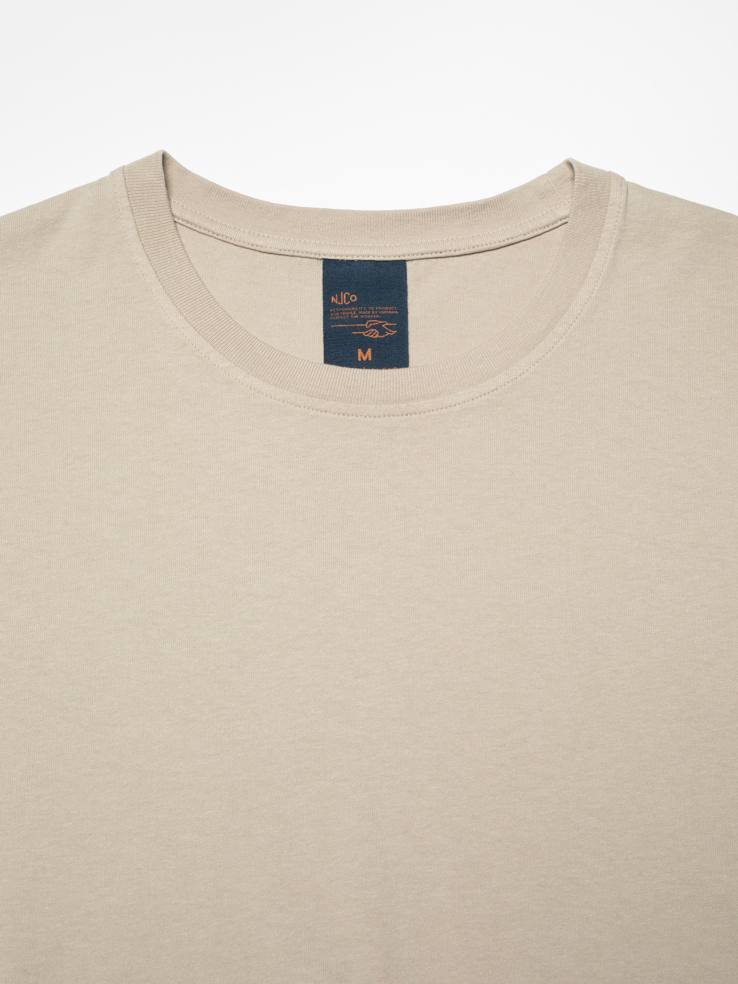Nudie Jeans Uno Everyday T-Shirt in Sand, close-up of the ribbed crew neck and internal brand label.