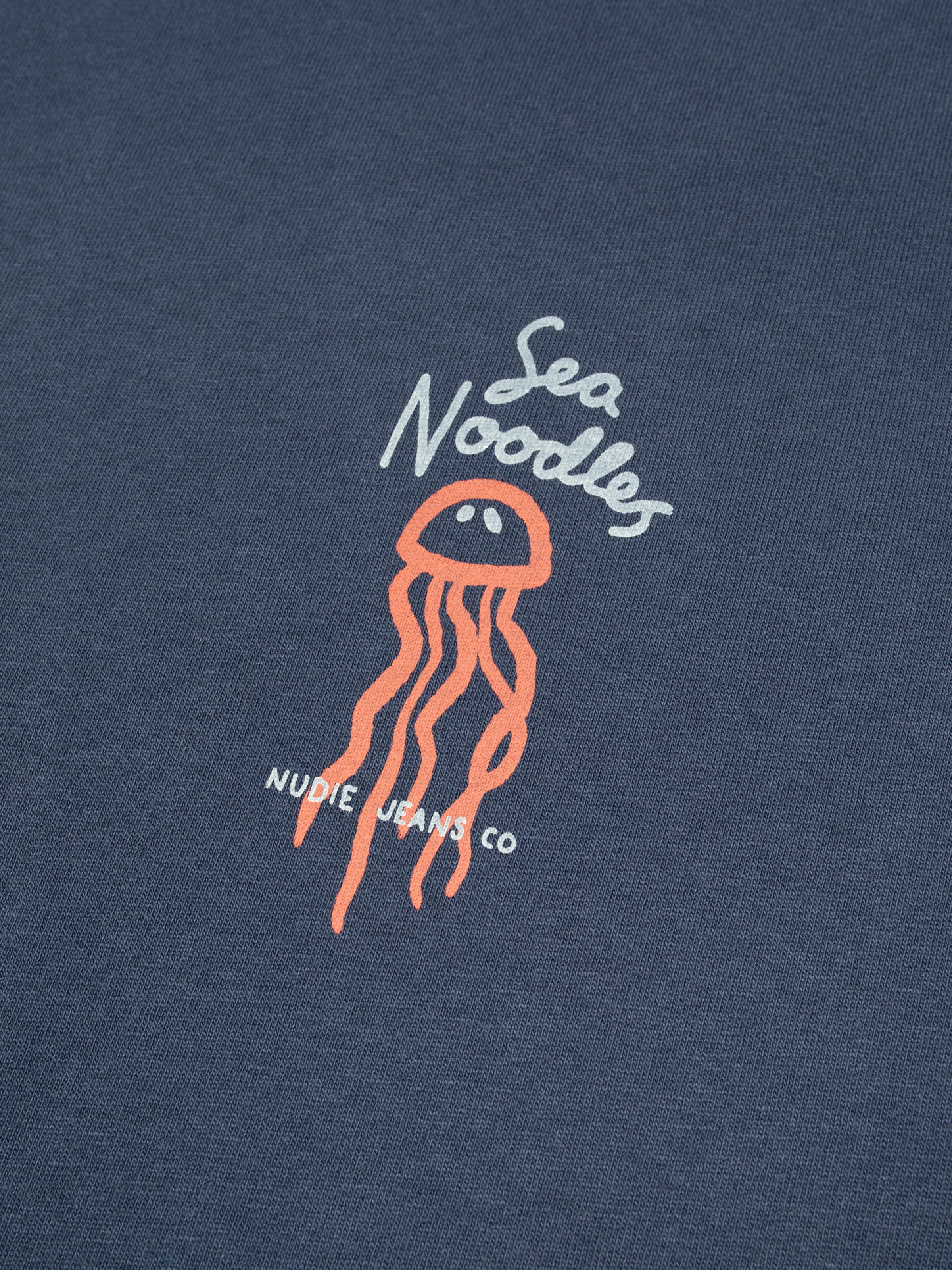 Nudie Jeans Roy Sea Noodles T-Shirt in Dark Blue, close-up of the chest print featuring a jellyfish illustration.