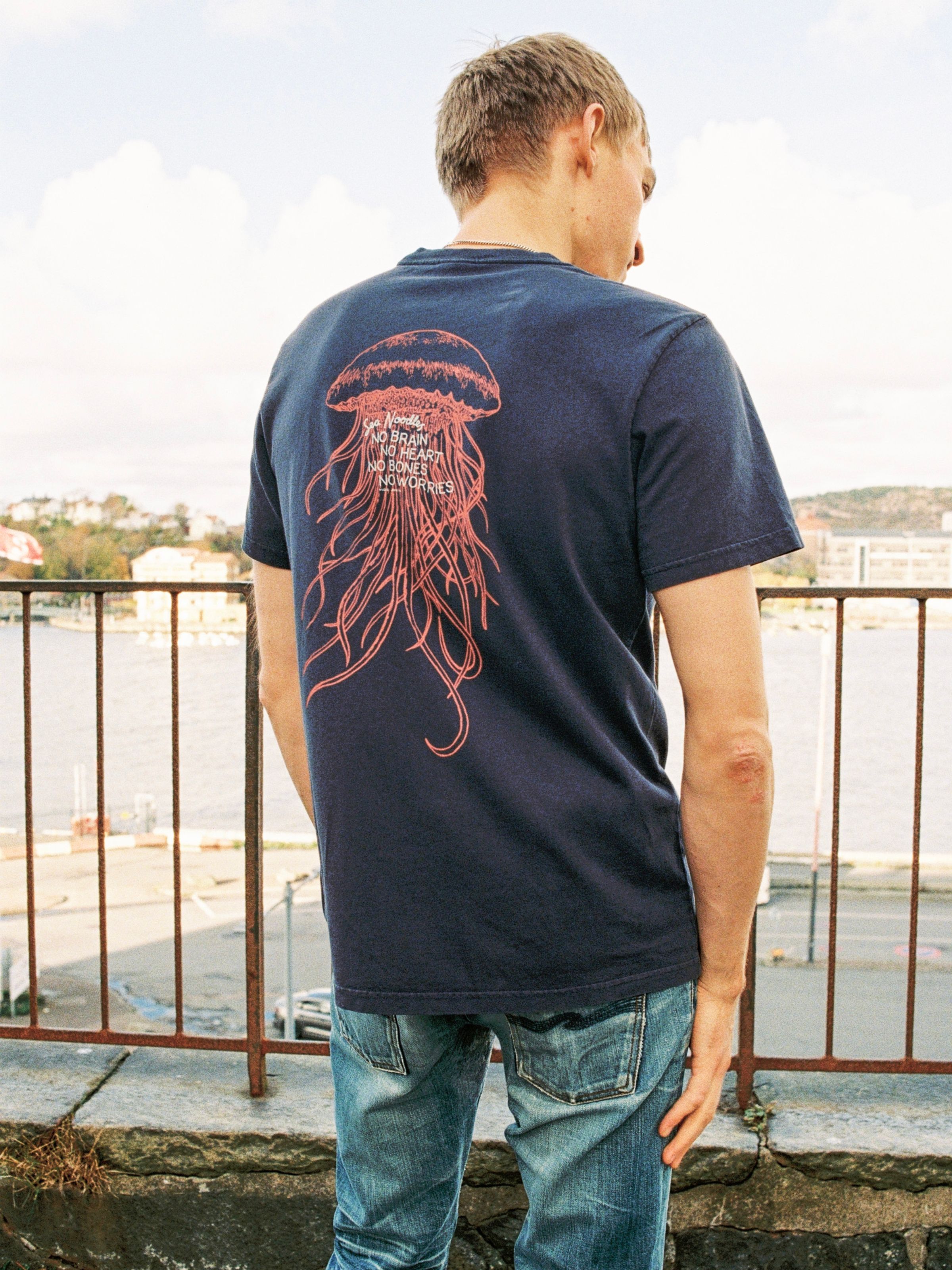 Nudie Jeans Roy Sea Noodles T-Shirt in Dark Blue, men's regular fit t-shirt shown from the back on a model.
