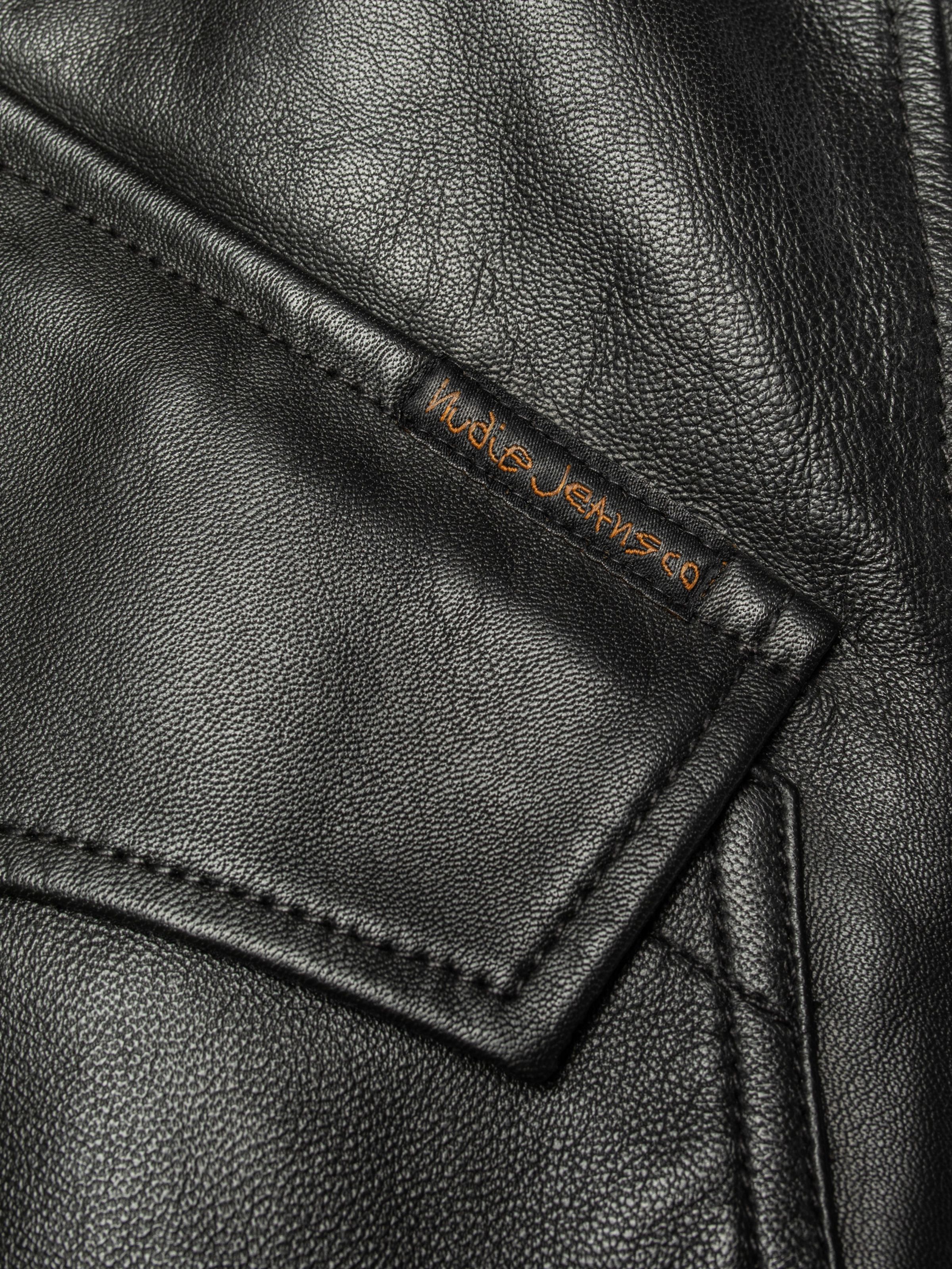 Nudie Jeans Blake Zip Jacket Leather Black, a close-up of the black leather pocket with the embroidered Nudie Jeans logo tab.