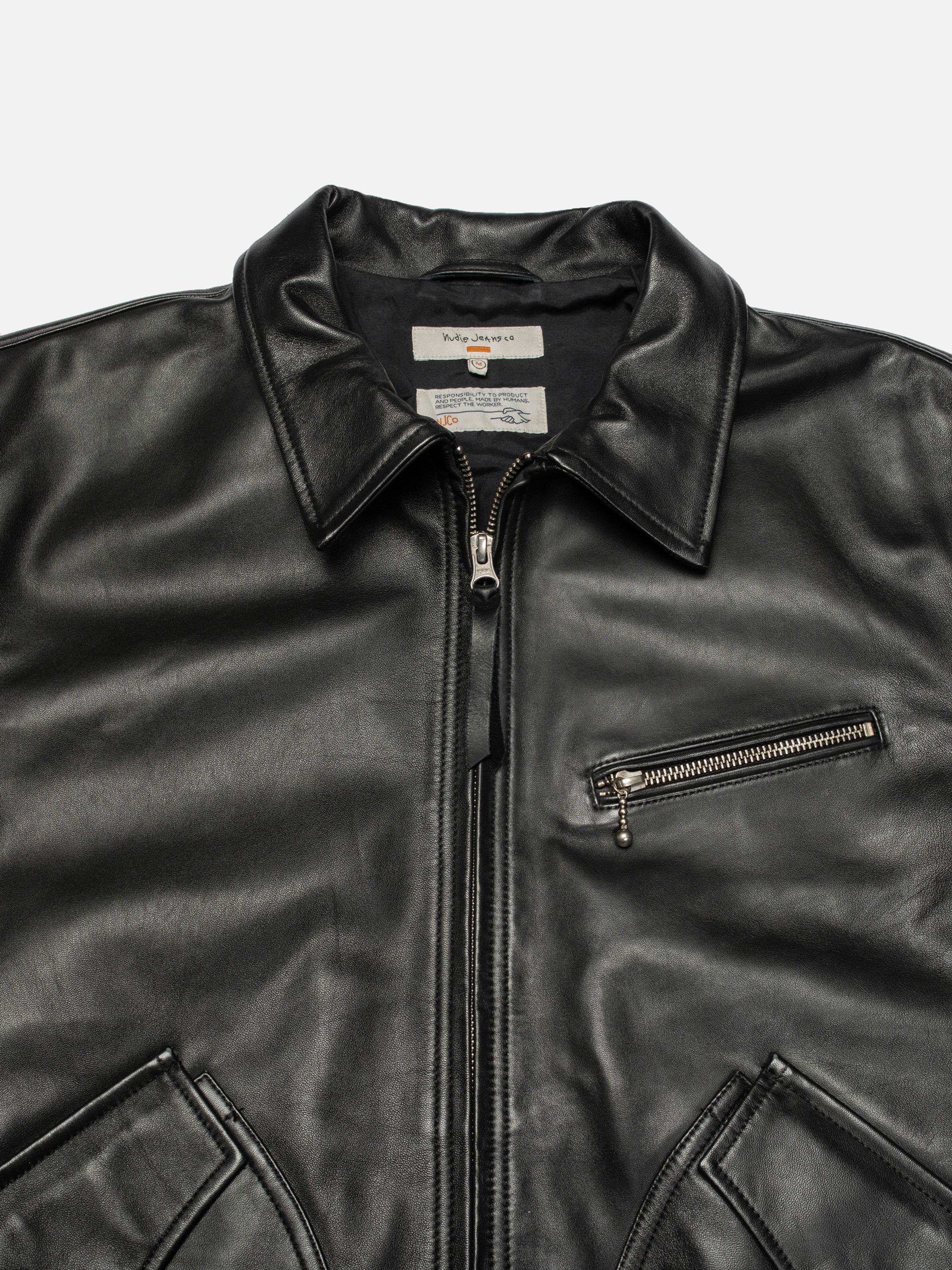 Nudie Jeans Blake Zip Jacket Leather in Black, a close-up shot showing the collar, zippers, and interior neck labels.