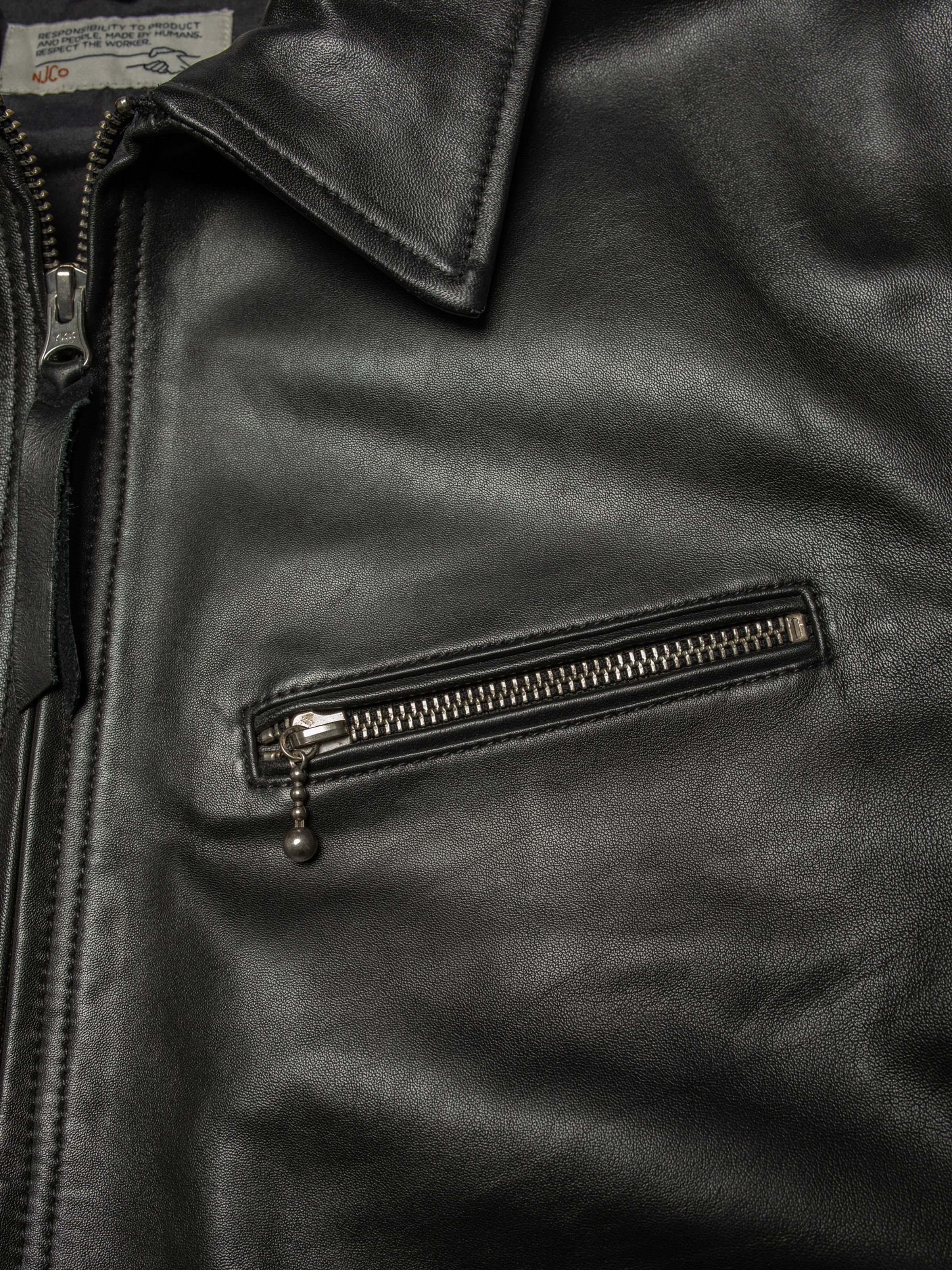 Nudie Jeans Blake Zip Jacket Leather Black, close-up of the chest pocket and collar.