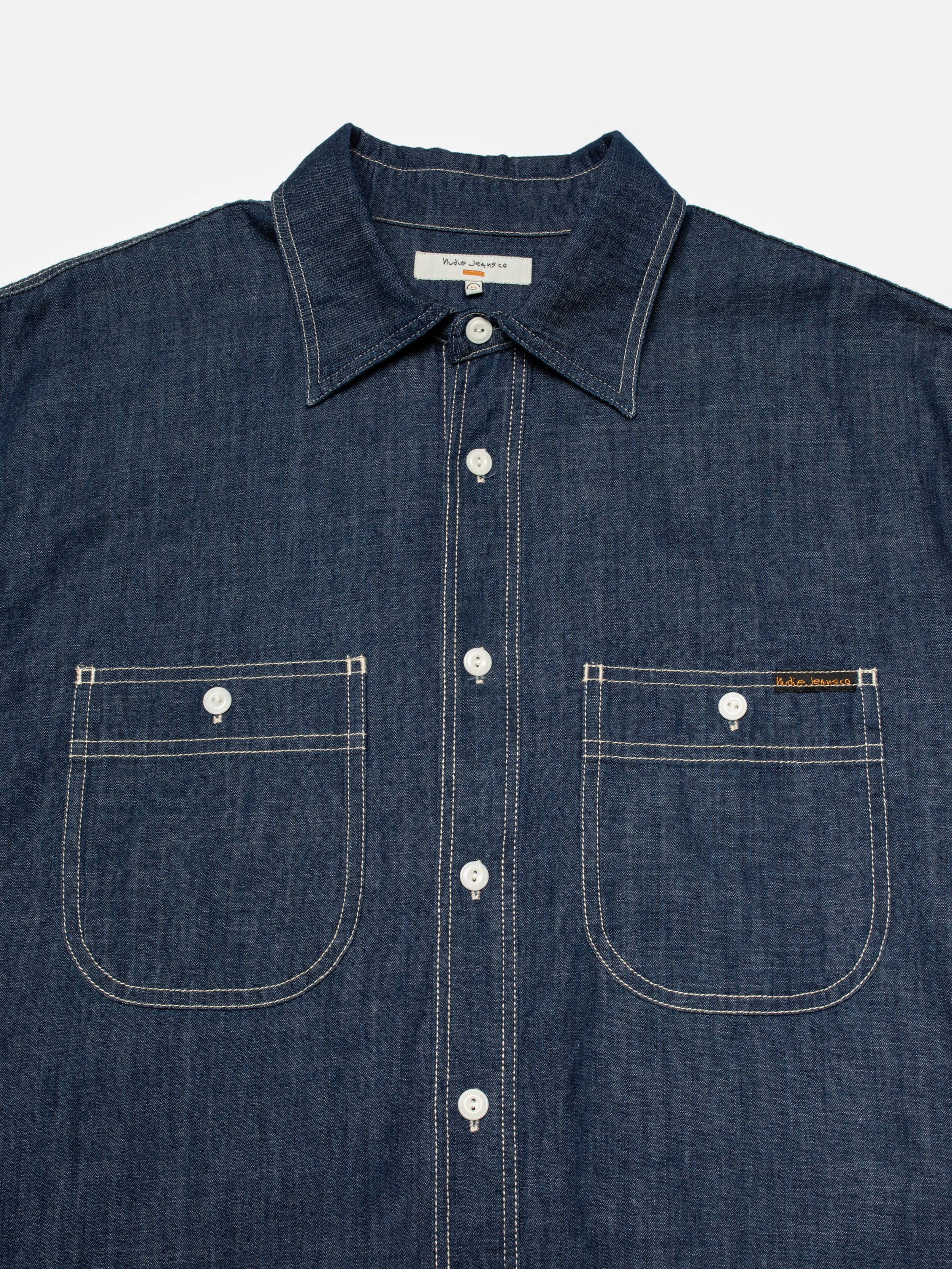 Nudie Jeans Julian Denim Shirt Rinsed, men's denim shirt shown in a close-up of the chest, collar, and pockets.
