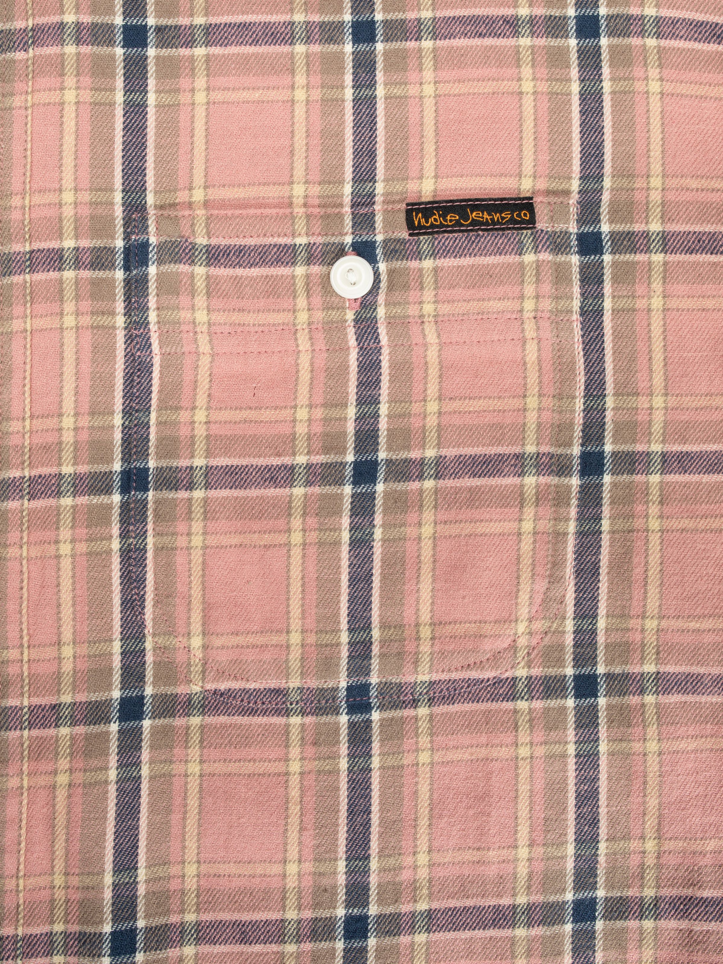 Nudie Jeans Julian Worker Shirt Checked in Pink, close-up showing the chest pocket and plaid fabric detail.
