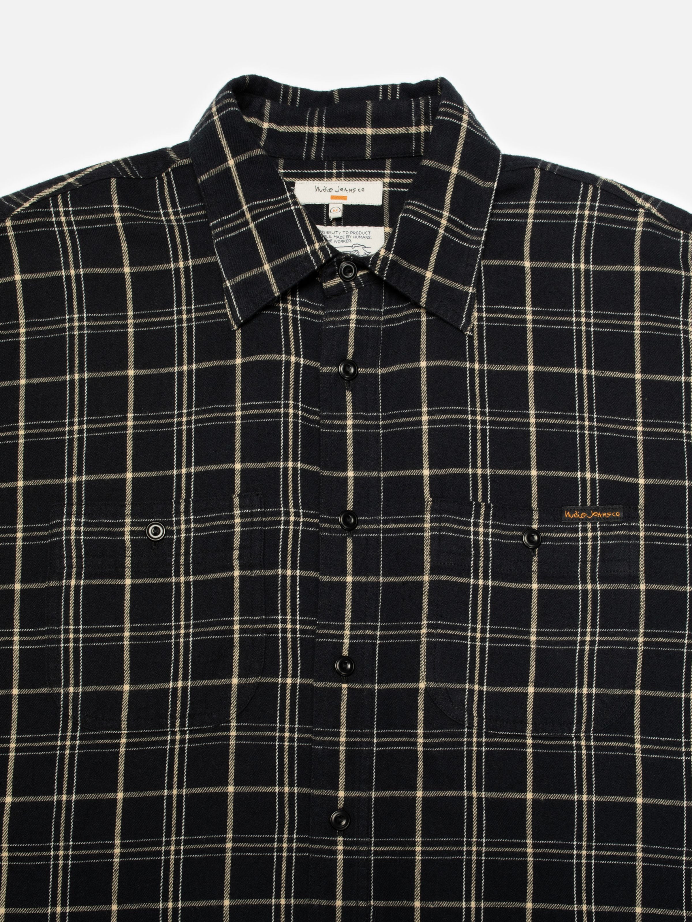 Nudie Jeans Julian Worker Shirt Checked in black, a close-up showing the collar, placket and chest pockets.
