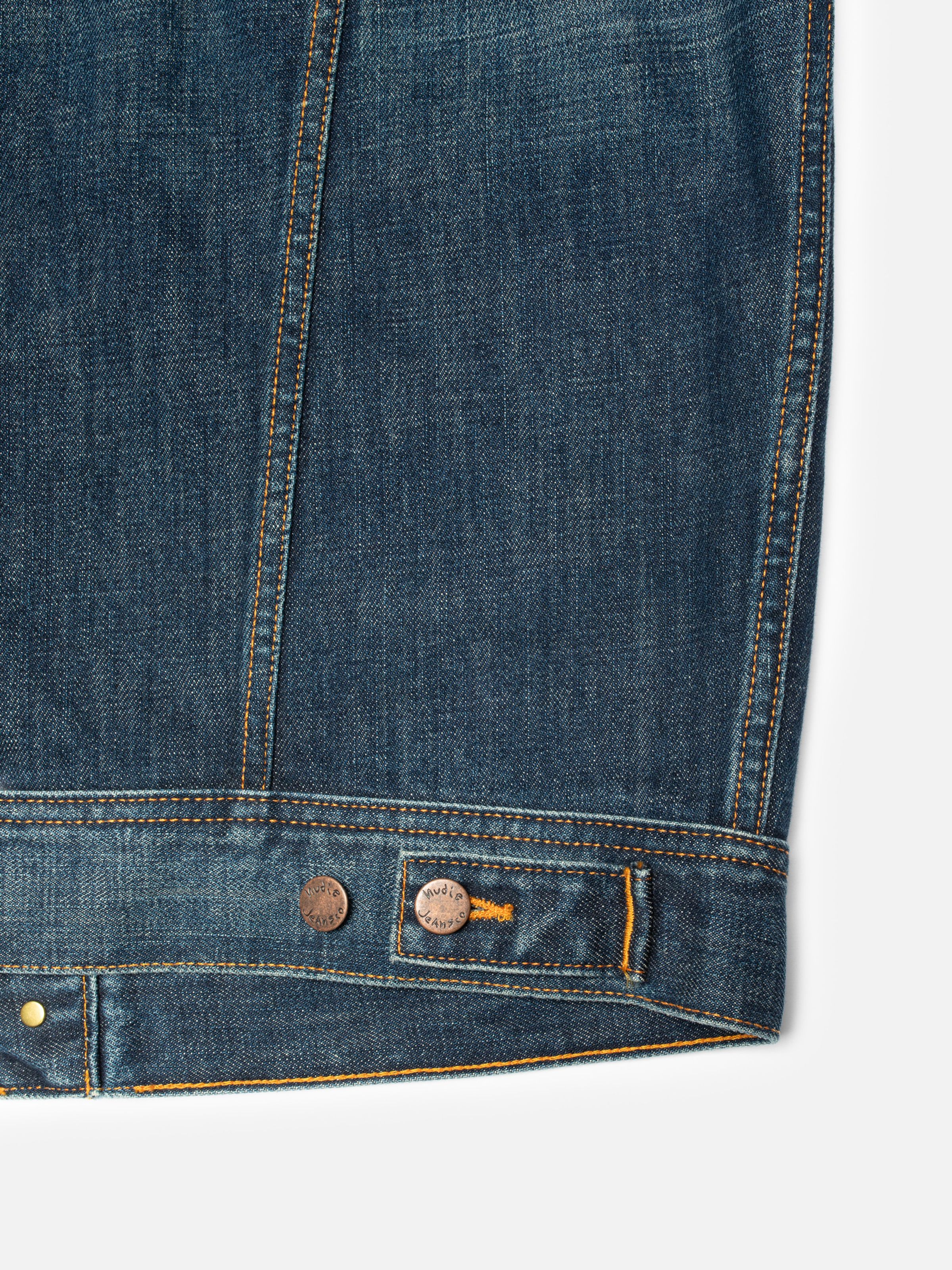 Nudie Jeans Conny Denim Jacket Heavy Used, close-up of the waistband showing copper buttons and orange stitching.