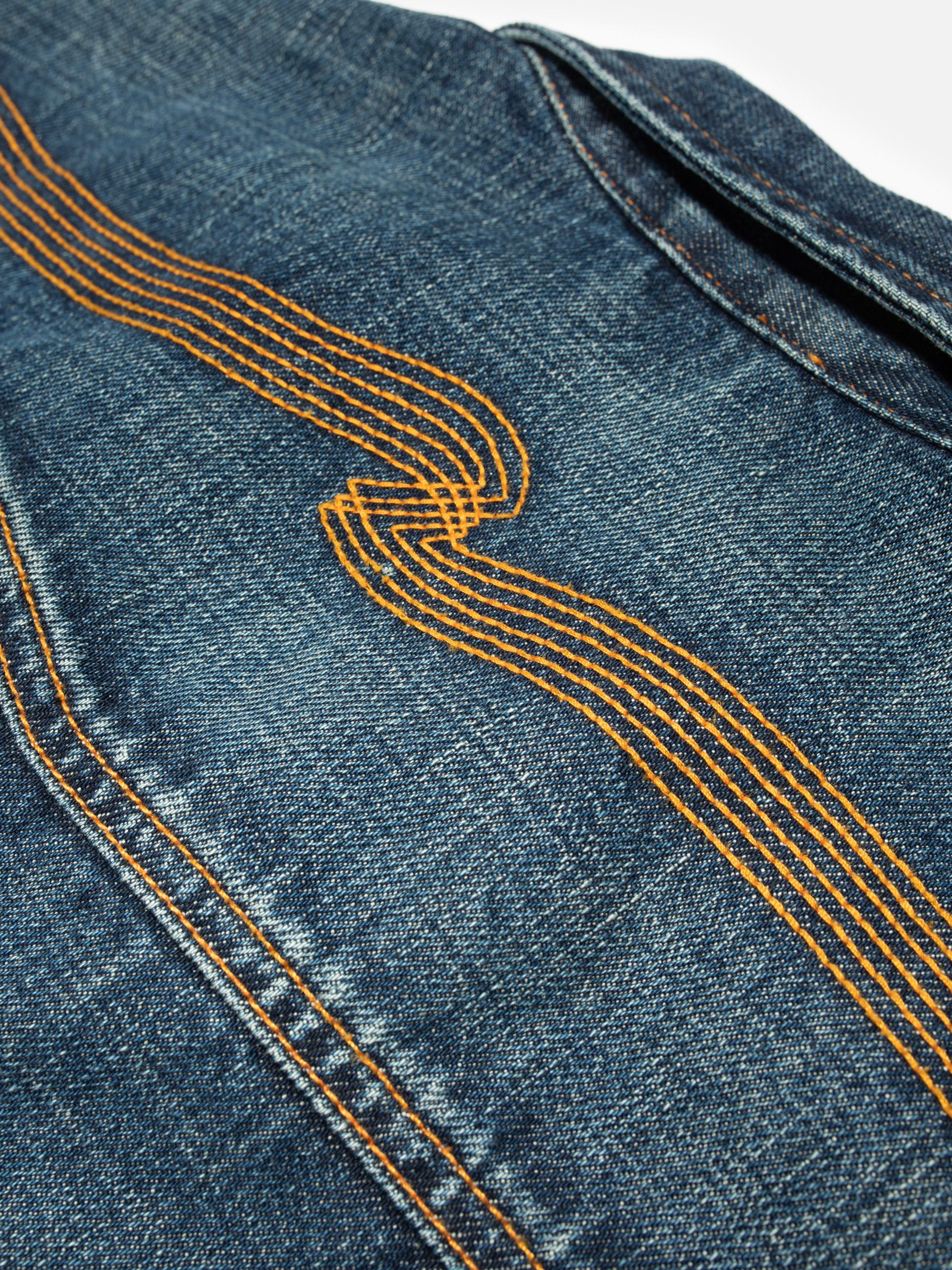 Nudie Jeans Conny Denim Jacket Heavy Used, close-up of the signature orange back yoke embroidery.