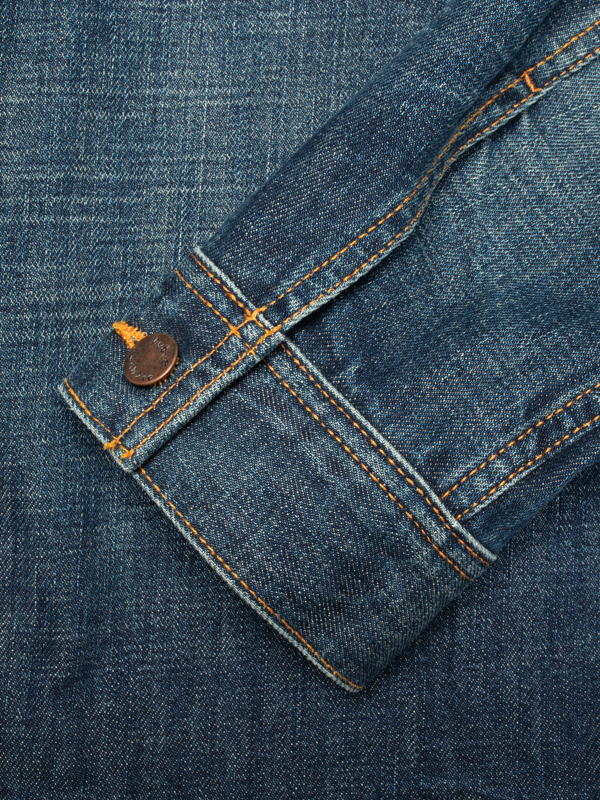 Nudie Jeans Conny Denim Jacket Heavy Used, close-up of the sleeve cuff showing orange stitching and copper button.