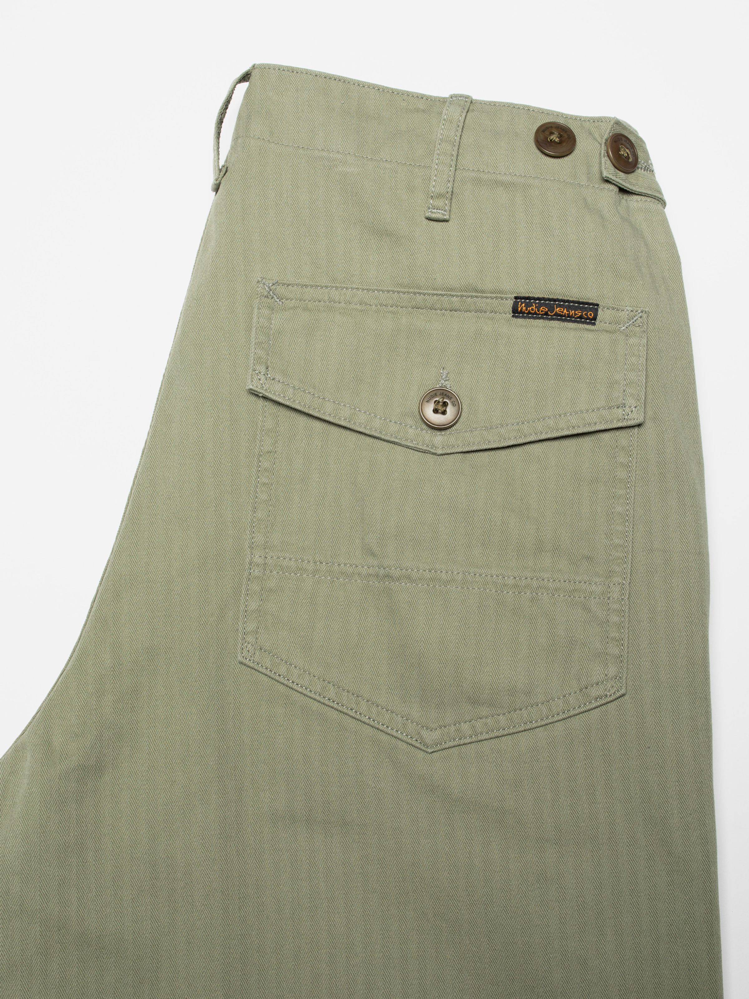 Nudie Jeans Tuff Tony Pants in Pale Green, men's loose fit pants, showing a close-up of the back pocket detail.