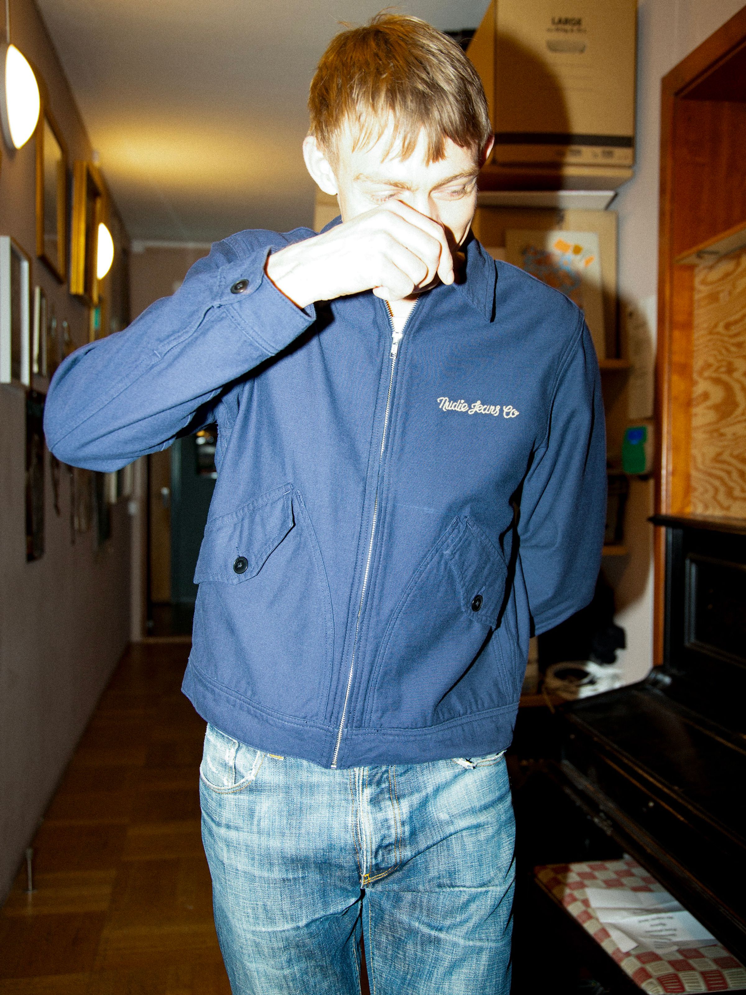 Nudie Jeans Blake Zip Jacket Back Sateen in Navy, a men's regular fit jacket shown on a model from the front.