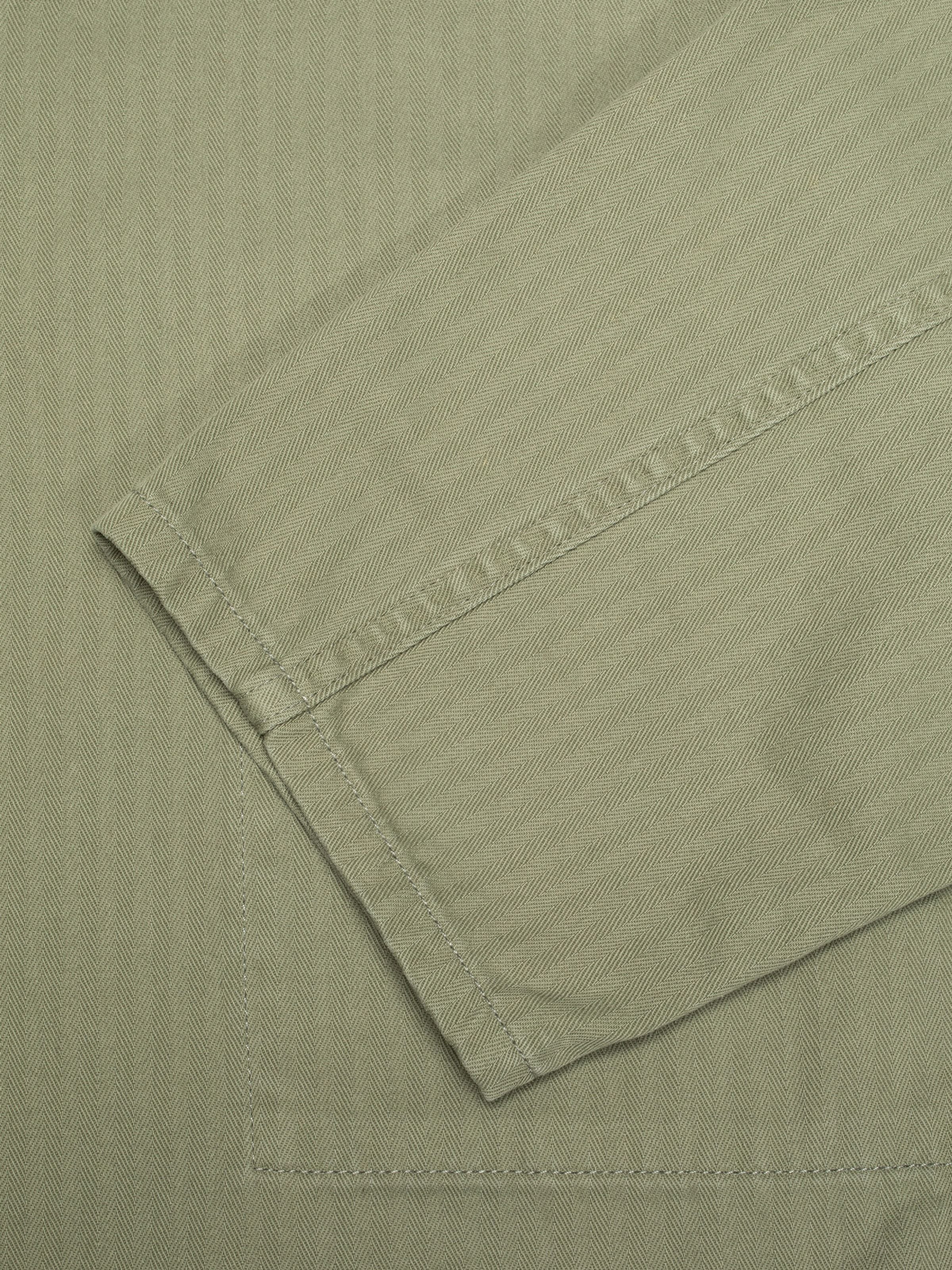 Nudie Jeans Buddy Chore Jacket Herringbone Pale Green, men's chore jacket, close-up of the herringbone fabric on the sleeve.