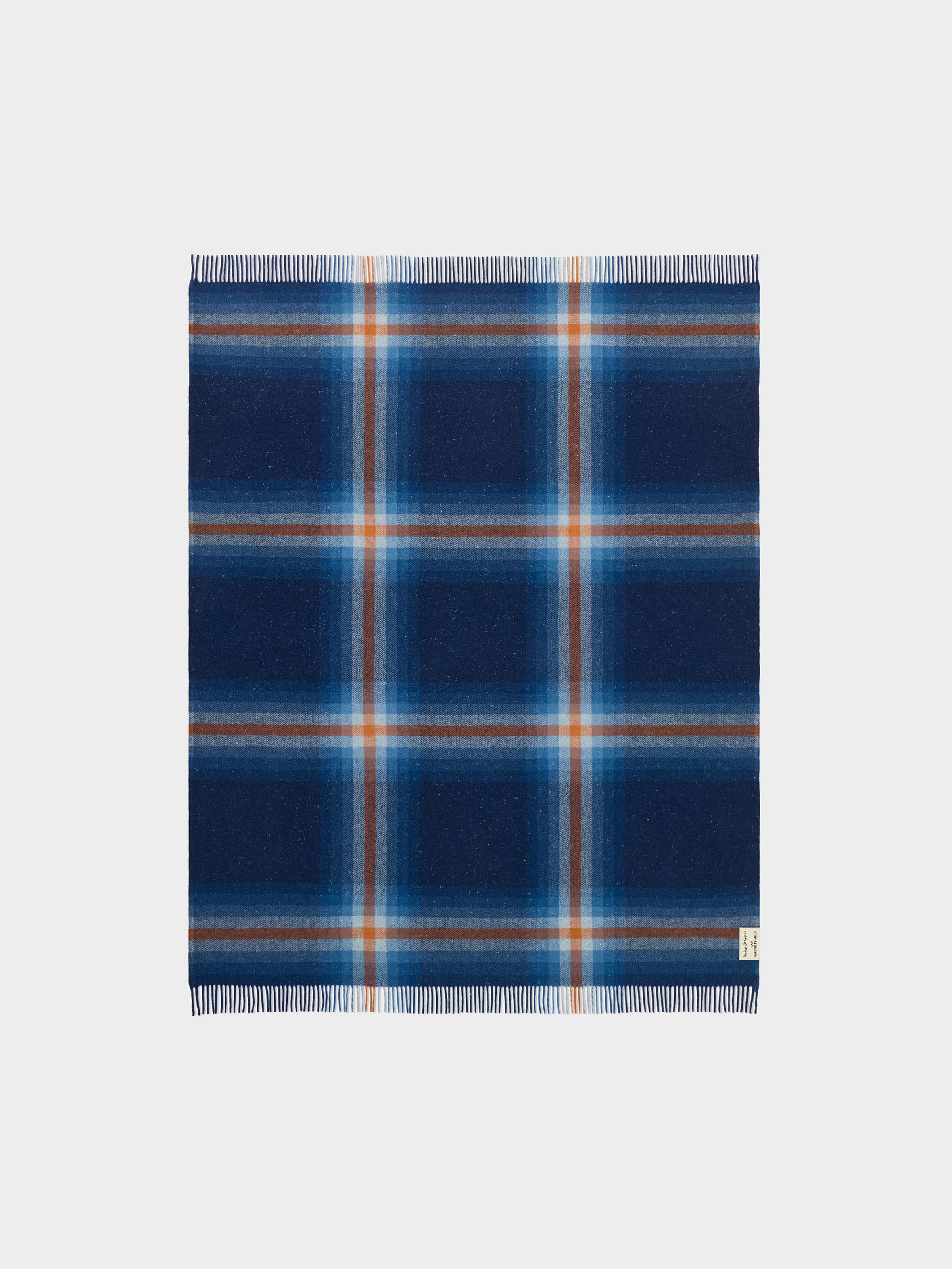 Nudie Jeans NJ x WM Recycled Blanket, a unisex recycled blanket in a blue and orange plaid pattern, shown laid flat.