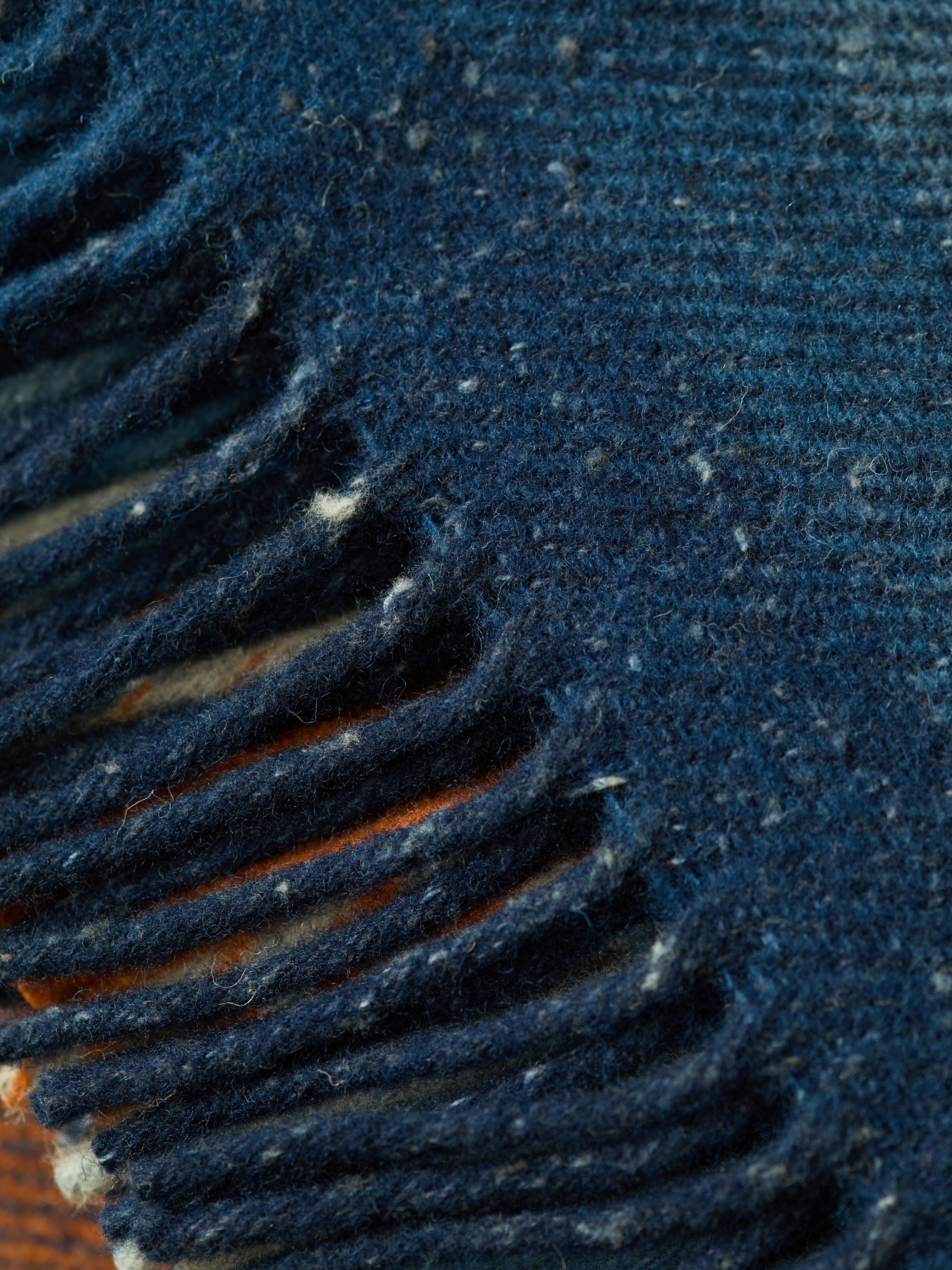 Nudie Jeans NJ x WM Recycled Blanket, showing a close-up detail of the recycled wool-blend fabric and its fringed edge.